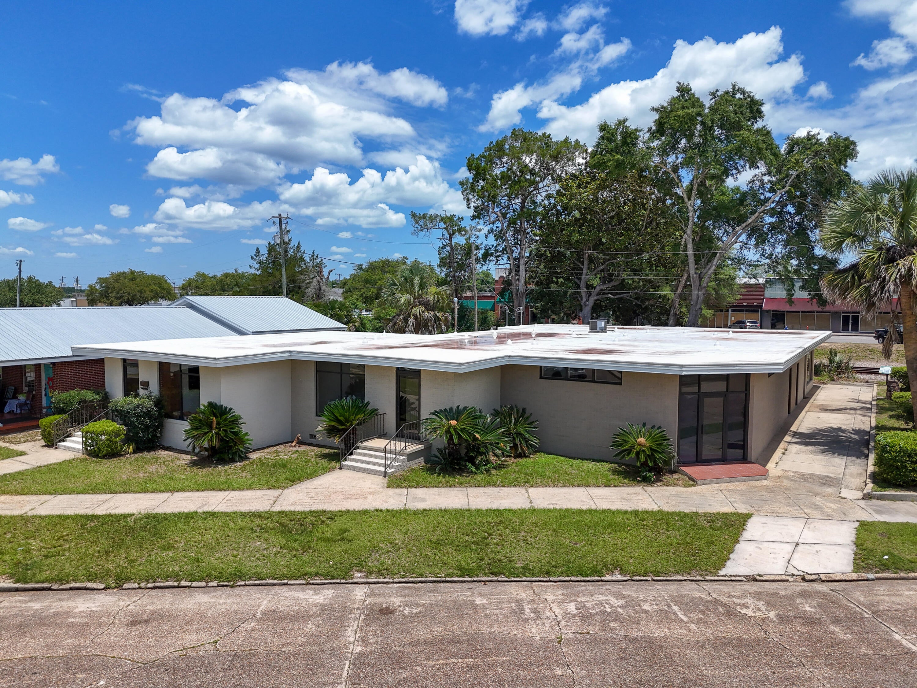 Rare downtown commercial lease in DeFuniak Springs, positioned across from Lake DeFuniak and the amphitheater with water views and substantial foot traffic. This corner space benefits from dual exposure along Circle Dr and Baldwin Ave, offering excellent visibility and signage opportunities. An inspiring setting for a gallery, studio, boutique or professional workspace. The layout includes a generous front room, three offices, two bathrooms, plus utility and storage. Corner windows flood the space with natural light, complemented by both front and rear entrances. See photos for floor plan. Projected availability 6/1. Four additional adjoining units of varying sizes are also under renovation and coming available. Exterior is being fully painted and updated - photos soon.
Tenant is responsible for utilities, internet and phone.