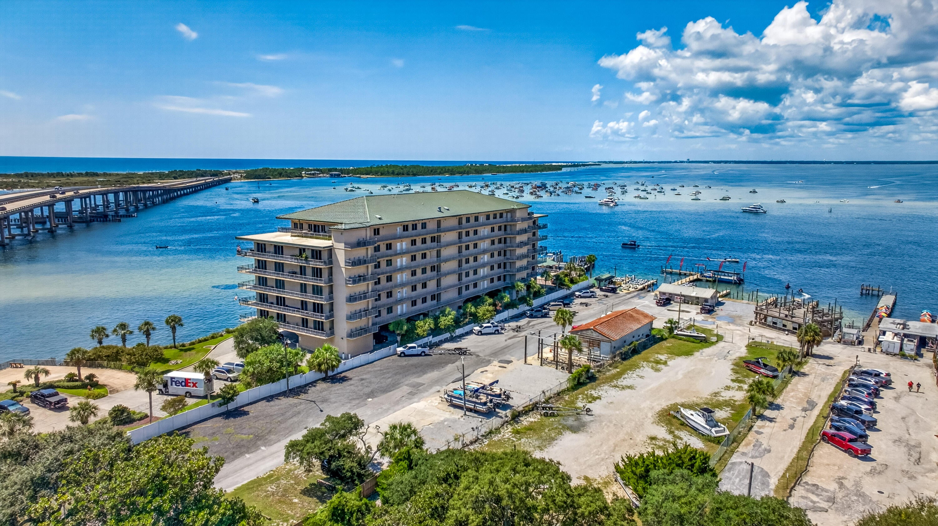 Unique waterfront condominium with a breathtaking million-dollar view! This gem is often overlooked due to its prime location, offering panoramic views of the Gulf, East Pass, Crab Island, and Destin Harbor. Rest assured, this well-built construction has passed all SIRS inspections in 2025, ensuring your safety and peace of mind. Floor-to-ceiling glass windows with a 140 MPH impact rating enhance the ambiance, while the interior is adorned with tile, carpet and wood flooring, custom cabinetry, wine refrigerator, ceiling fans, recent paint, 10-foot ceilings, stainless steel appliances, a ceiling tray/coffered design, and a pantry. Kitchen also has pot filler. The meticulously maintained interior exudes a sense of newness, thanks to an abundance of natural light that floods every room. Imagine waking up to the beauty of the waterfront and enjoying a luxurious coastal retreat every day. Awesome views of Crab Island and your own ''private beach.'' All rooms have a view of the Destin Harbor. This home is perfect for the active couple who craves adventure and seeks a luxurious coastal escape. This condo has 1 assigned space and storage unit. This unit does not come with a boat slip.  Don't miss this opportunity to own your piece of paradise!!!