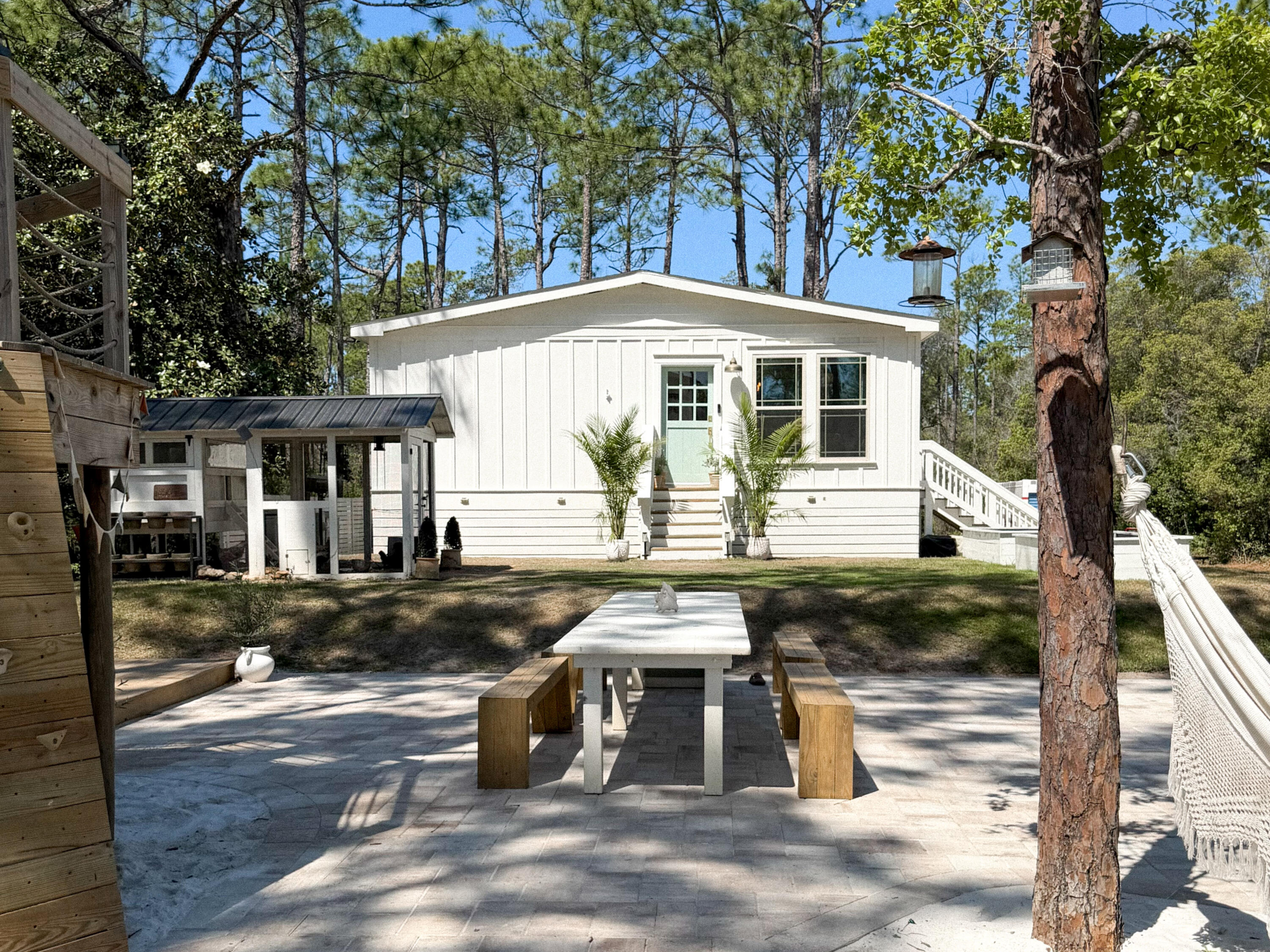 One of Santa Rosa Beach's most unique properties. Beautifully remodeled 3BR/2BA home on a combined double lot just off 30A, approx. 1/2 mile to the beach, 5 deeded beach access points and no HOA. Built in 2022 and fully remodeled in 2026,this 1,230 SF coastal cottage offers Hardie board & batten exterior, Dutch front doors, Pergo LVP flooring, quartz countertops, shaker cabinetry, remodeled baths, and a high-end Forno white/brass appliance package with induction range. Rare 30A privacy with a spacious yard for entertaining, tucked back at end of cul-de-sac, with beautiful views of the bordering state forest. Built for outdoor living with new pavers, expansive grass lawn, white-sand fire pit, custom 10x16 shed, 2 RV hookups, walk-in chicken shelter, garden beds, and large storybook treehous Private drinking well w/ high-end filtration, 400amp power, septic system, tankless water heater. Renovated RV may stay. Water/sewer/gas/fiber at street. Off/On grid capable. Future lot split possible