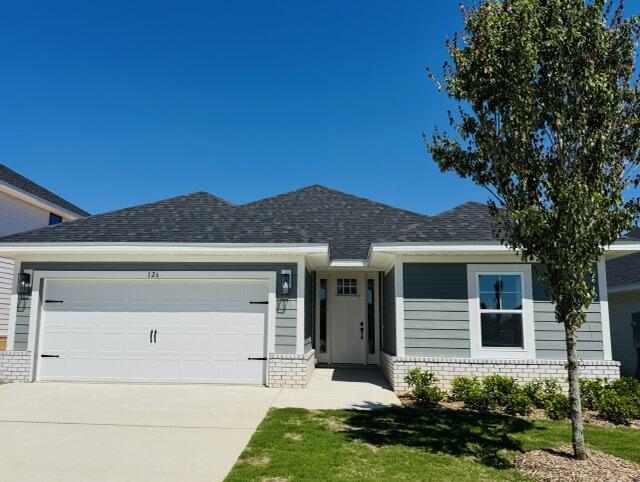 Located just a 20-minute drive to the white-sand beaches of South Walton, this Craftsman-style home blends coastal convenience with modern comfort. Offering 3 bedrooms and 2 baths, the home features Hardiboard siding with a brick skirt, 9' ceilings throughout, and elegant 10' tray ceilings in the owner's suite. Quartz countertops highlight the kitchen and baths, complemented by sleek black faucets and hardware. Durable CoreTec Pro Plus luxury vinyl plank flooring flows throughout, while the oversized owner's suite with a large walk-in closet provides a relaxing retreat. Photos are of a similar home.   Adams Homes pays most closing costs!