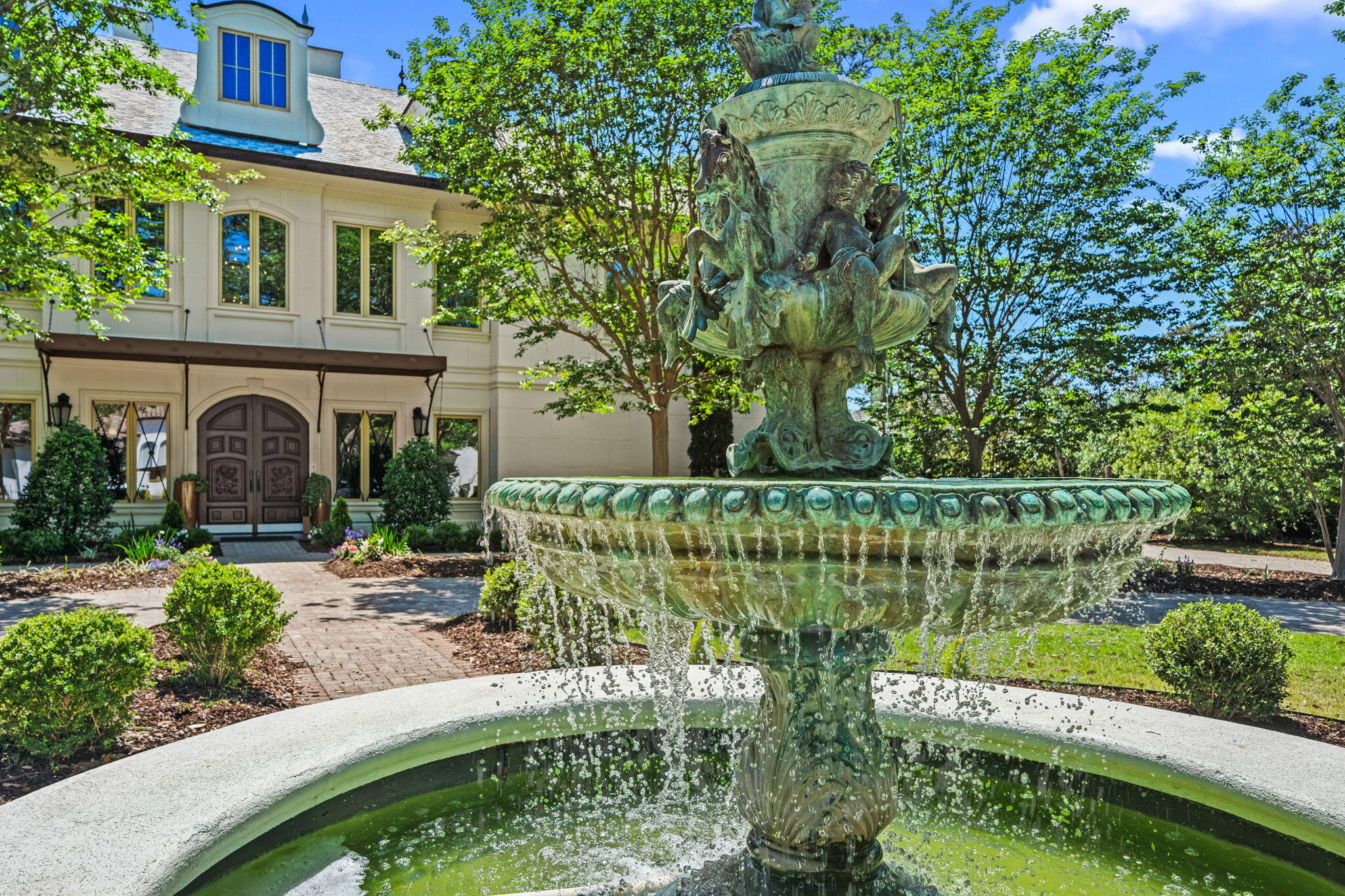 Welcome to 434 Captains Circle--an extraordinary European-inspired French Château, gracefully positioned within the prestigious, guard-gated enclave of Regatta Bay. This private, 24/7 secured sanctuary offers a rare blend of refined elegance and coastal serenity, meticulously crafted for both grand-scale entertaining and elevated everyday living. Set on 1.23 acres of lush, manicured grounds and constructed with ICF for enduring strength and efficiency, this custom estate is a testament to timeless design and impeccable craftsmanship. Uniquely sited right off the tranquil shores of Choctawhatchee Bay, the residence boasts over 80 feet of waterfront, framed by native sawgrass and an untouched nature preserve--offering a truly serene and picturesque backdrop. Encompassing nearly 8,000 square feet of exquisitely appointed interiors, this architectural masterpiece embodies the art of fine living, where grand proportions and classical French design converge with modern comfort. Each room has been thoughtfully curated to exude casual luxury, timeless detail, and an effortless sense of sophistication.

As you arrive at this stately estate, you're welcomed by mature, manicured landscaping and an expansive brick paver circular drive centered around an exquisite Italian fountain perfectly framing the limestone-clad façade of this chateau-inspired masterpiece. Constructed with nearly 9-inch thick poured concrete exterior walls, the home offers unparalleled structural integrity and timeless grandeur. The entrance is marked by a pair of magnificent, hand-carved mahogany doors, each standing 8 feet tall, opening into a breathtaking two-story foyer crowned with a soaring 22-foot domed ceiling. A sweeping freestanding curved staircase known as the 'wedding' stair graces the space, crafted in rich wood and adorned with intricate ironwork. Italian marble columns, dual Juliette balconies, and grand architectural symmetry elevate the ambiance. Throughout the estate, natural oak hardwood floors, 10-foot ceilings, and lavish Venetian plaster walls are complemented by elaborate millwork, including 14-inch baseboards and crown moldings ranging from 8 to 14 inches each detail a testament to timeless artistry and refined craftsmanship.

Just off the grand foyer, refined functionality allows access to a tastefully appointed powder room, a private elevator, and two oversized garages accommodating up to four vehicles and/or a golf cart, complete with newly finished polyaspartic-coated floors for a sleek, durable finish. Beyond the foyer, the estate opens to expansive, light-filled living spaces framed by grand windows and elegant French doors, inviting in an abundance of natural light. The formal dining room is an entertainer's dream, currently showcasing an ornate Italian table that comfortably seats twelve beneath a custom-painted ceiling medallion and a striking Art Deco-inspired glass chandelier. The chef's kitchen is both stylish and functional, featuring refreshed custom cabinetry with sleek contemporary hardware, granite countertops and backsplash, a spacious walk-in pantry with custom shelving, a generous center island, and a separate breakfast bar. High-end appliances, including a Sub-Zero refrigerator, Thermador double ovens, Viking gas range and microwave, and more, ensure culinary perfection in every detail. Anchoring the living area is a stunning marble gas fireplace flanked by custom wood built-ins, offering warmth and timeless charm. Hidden within the home's refined design are two private studies what we fondly call its 'secrets.' One office exudes soft elegance with lighter tones, built-in bookcases, and dual French Empire crystal chandeliers, while the second office/den is richly appointed with Brazilian wood accents, intricate custom shelving, dramatic 10-foot Italian marble columns, wood-paneled walls, and wood-coffered ceilings evoking the grandeur of a European gentleman's library.

Occupying the second floor, the opulent primary suite offers a private sanctuary of sophistication and comfort. A serene balcony overlooks the pool area, while a marble-clad gas fireplace adds warmth and timeless elegance. Rare and indulgent, the suite boasts dual spa-inspired ensuites, each with its own distinct design narrative. One bath evokes a coastal serenity with soft hues of cream and blue, featuring a freestanding tub/shower, a water closet, oak wood floors, a waterfall-inspired glass sink, granite countertops, makeup vanity, custom cabinetry, and an expansive custom walk-in closet. The second bath channels a Roman-inspired ambiance with rich tan and cream tones, heated marble floors, a marble walk-in shower, private sauna, traditional single vanity, and its own custom walk-in closet. This extraordinary suite redefines luxury living with thoughtful design and unparalleled comfort.

The second level hosts three additional generously proportioned bedroom suites, each a private sanctuary featuring its own architecturally distinctive en-suite bath. Appointed with granite-topped single vanities, private water closets, and custom tiled walk-in showers (one suite also boasting a deep soaking tub) these retreats combine timeless elegance with modern comfort. Custom walk-in wardrobes complete each suite, offering both style and function. Adjacent to the bedrooms, a spacious utility room enhances daily living with custom cabinetry, granite countertops, and an oversized utility sink thoughtfully designed for seamless multitasking and refined efficiency. The third floor is devoted to a refined entertainment suite. At one end, a cozy cinema lounge adjoins a discreet half bath. The central space features a classic billiards table, while the far end offers a stylish gaming corner and bespoke wet bar ideal for relaxed, sophisticated gatherings.

The grandeur of the estate continues beyond its walls, where the outdoor living spaces are nothing short of enchanting. A private, resort-style oasis awaits within the fully enclosed lanai, elegantly finished with travertine tile flooring and centered around a spectacular 19' x 36' pool and an 8' x 8' elevated spa. A dedicated outdoor pool bath adds convenience, while every element has been thoughtfully designed for both lavish entertaining and serene relaxation. The alfresco experience is elevated by a fully appointed outdoor kitchen and bar, featuring top-of-the-line Viking and Lynx appliances, including a gas grill, gas stove, dual refrigerators, and a professional-grade pizza oven. Multiple fire features a gas fireplace with mounted television, a natural gas firepit, and a charming wood-burning firepit create inviting ambiance day or night. Extending the luxury to the water's edge, a private, 300-foot lighted pier leads to the tranquil canal just off Choctawhatchee Bay. Complete with a picturesque sitting area, it offers a serene vantage point for morning coffees, sunset reflections, or effortless access to the waterway by boat completing this exceptional coastal retreat.

Thoughtfully designed for refined living, this exquisite château offers timeless elegance and effortless comfort just moments from the best of the Emerald Coast. A rare offering that must be experienced to be truly appreciated.