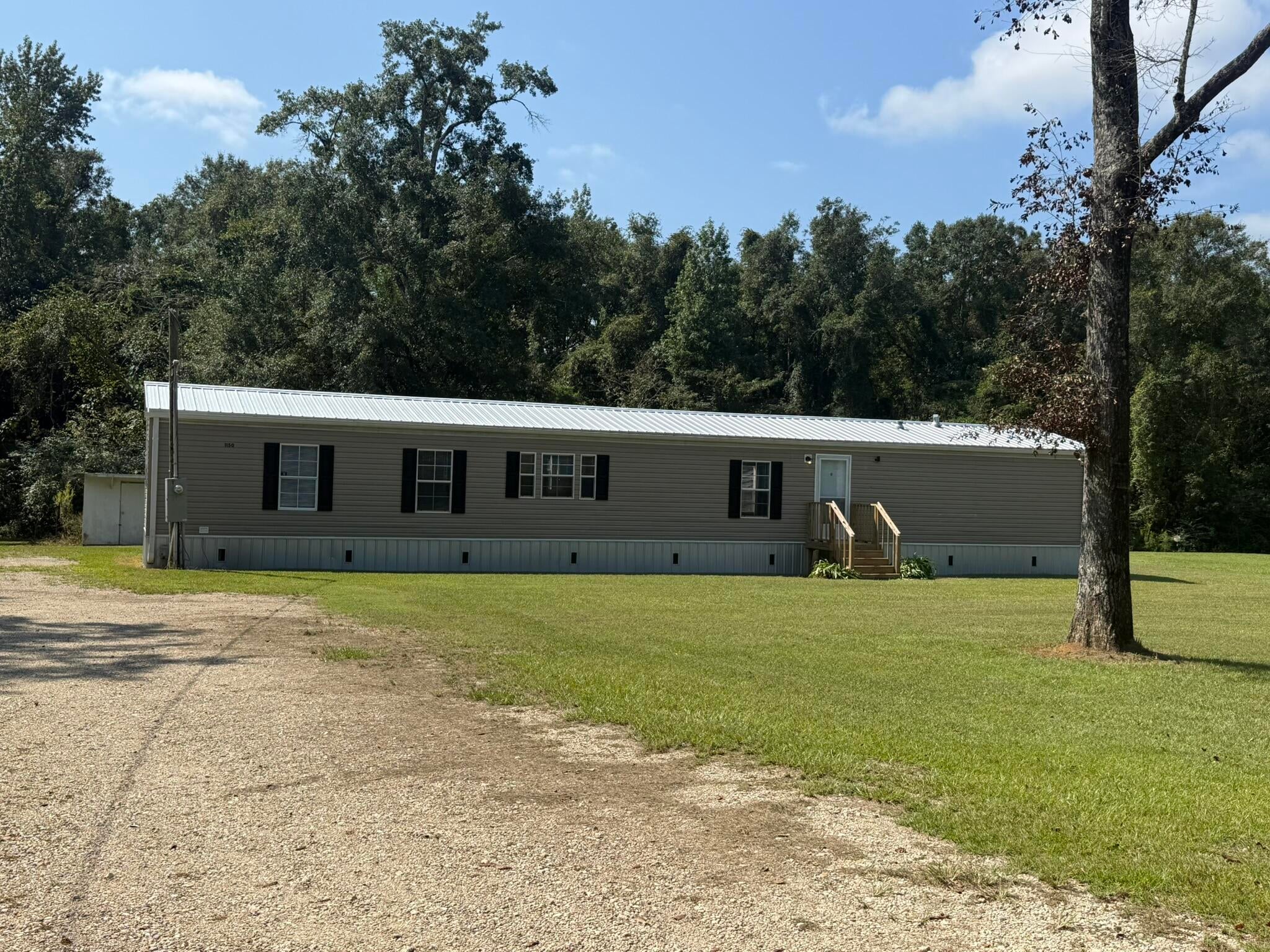 Welcome to 1150 Reeves Road in Baker! Situated on a full acre, this newly remodeled 3-bedroom, 2-bath home offers a fresh, updated feel with the space and country setting you've been looking for. Inside, you'll find a functional split-bedroom floor plan, spacious living area, eat-in kitchen with plenty of cabinet and counter space, and a comfortable primary suite. Outside, enjoy the covered back deck and plenty of room for your boat, trailer, outdoor equipment, or future projects. The property also includes a storage building with additional covered storage areas. Located on a paved road just minutes from the heart of Baker, this move-in-ready home offers a great combination of country living, modern updates, privacy, and convenience. Schedule your showing today!