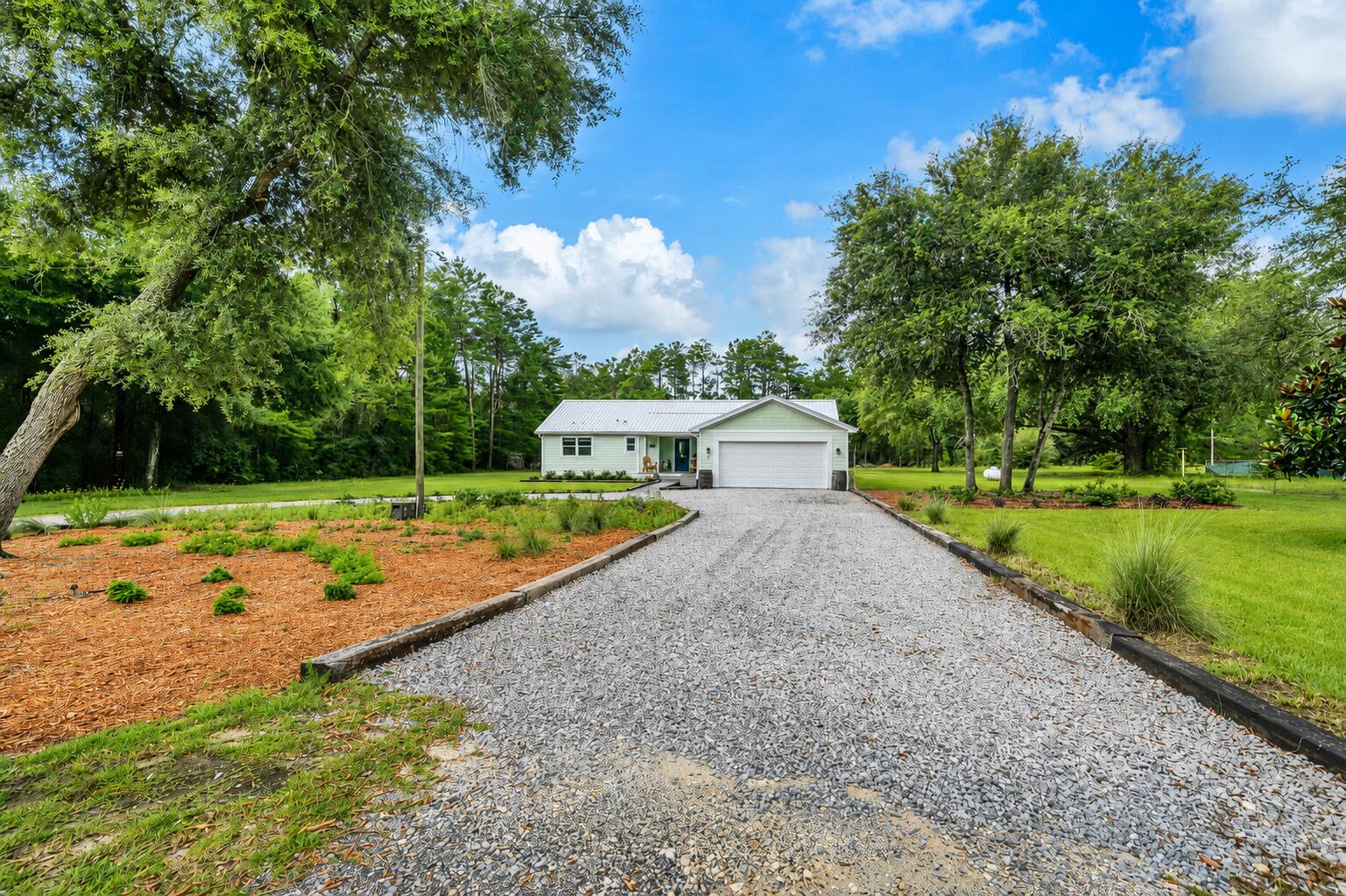 Finding a beautifully renovated home isn't difficult. Finding one that's beautifully renovated on approximately 1.25 acres with room for your RV, a fenced backyard, greenhouse, storage shed, and no HOA is another story. Nearly every finish has been replaced, giving this home the look and feel of new.
Step inside to an open floor plan where Timberline water proof flooring flows throughout the home. The inviting living room features a shiplap accent wall with an electric fireplace, while the beautifully redesigned kitchen offers quartz countertops, soft-close cabinetry, stainless steel appliances, designer lighting, and an oversized island that's ready for everything from weeknight dinners to holiday gatherings.
The spacious primary suite is a retreat of its own with a beautifully appointed bathroom featuring dual vanities, custom cabinetry, abundant storage, and an oversized tiled walk-in shower. Every room reflects the care and attention that went into creating a home that's as beautiful as it is comfortable.
The improvements extend well beyond what you can see. Enjoy added peace of mind with a 2024 roof featuring peel-and-stick underlayment, a 2024 water heater, impact-rated exterior doors, an impact-rated garage door, and impact-rated windows throughout the home (with the exception of the garage window).
Outside, approximately 1.25 acres gives you the freedom that's becoming harder to find. Park your RV, enjoy the greenhouse, organize your tools in the storage shed, let pet roam safely in the fenced backyard, or simply relax on the covered back porch and enjoy the quiet. If you've been searching for a home that offers the beauty of a complete renovation and the space to truly live, you've just found it.