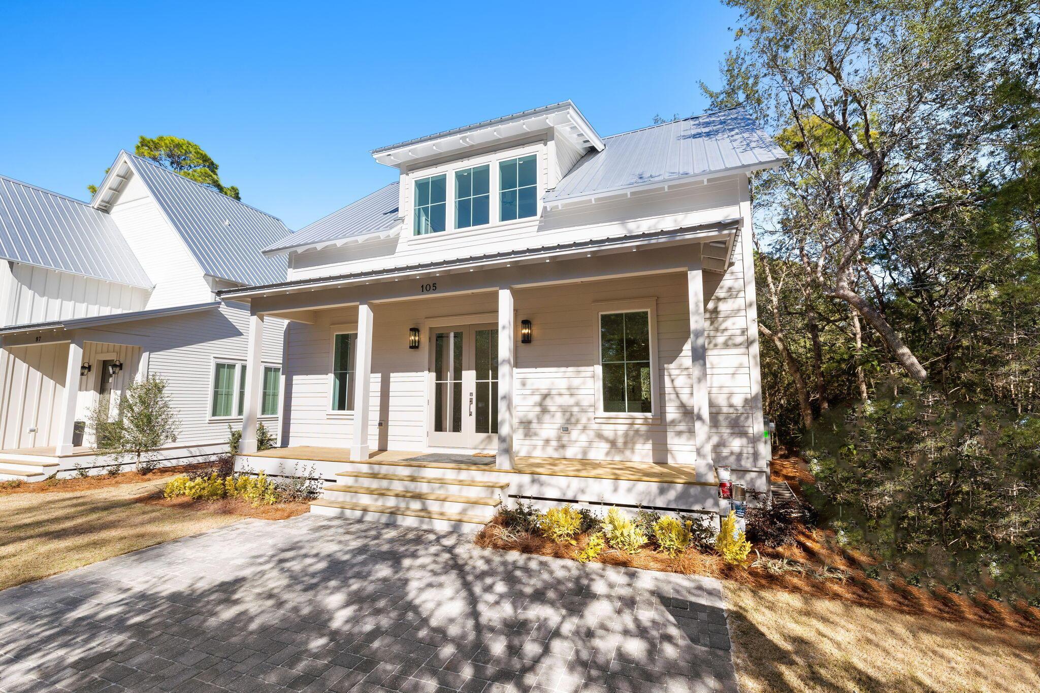 Tucked into the heart of Point Washington, this Craftsman cottage at 105 Greenbriar Lane delivers thoughtful design at every turn. Shiplap walls, custom cabinetry, quartz countertops, and wide-plank hardwood floors set a warm, elevated tone throughout - complemented by designer fixtures and finishes selected with care. The masterfully planned layout offers four oversized bedrooms, each with a private en-suite bath, a first-floor primary suite, an expansive open-concept great room, a secondary living area on the upper level, a powder room, and a sprawling screened porch made for year-round enjoyment. In the chef's kitchen, a 36'' gas range and stainless steel refrigerator anchor a space built for both cooking and gathering. Nestled within Grayton Bayou - just steps from Choctawhatchee Bay and a short bike ride from the white sandy beaches of 30A - this home is a rare find in one of the Emerald Coast's most charming communities.