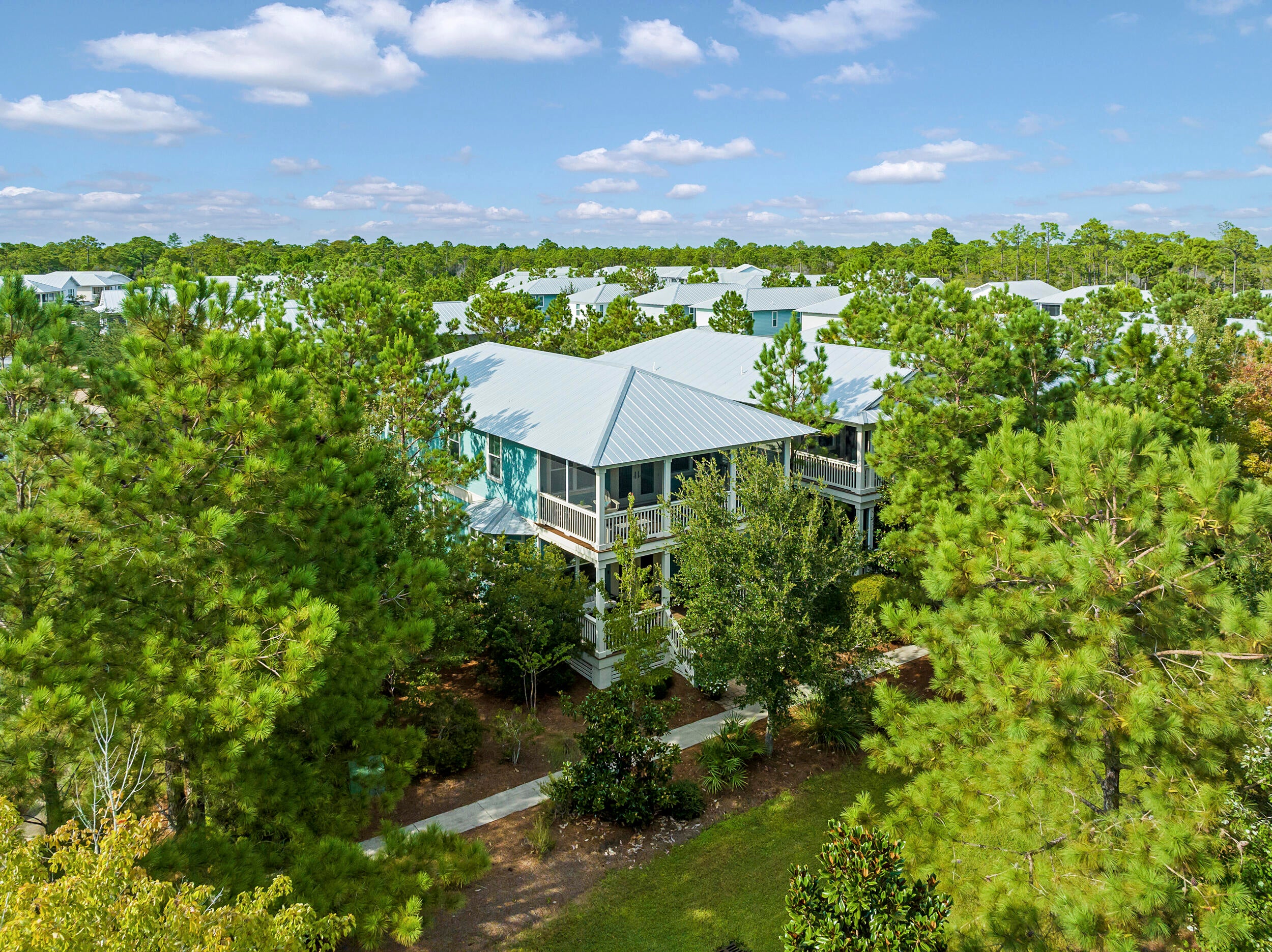 Welcome to 8 Lovegrass Way, a beautifully maintained and never-rented home offering exceptional privacy in the sought-after NatureWalk at Seagrove community. Situated on a desirable corner homesite and surrounded by mature trees, the home creates a peaceful, elevated treehouse-like setting. The front of the property overlooks green space, providing the perfect place for children or four-legged family members to play.
One of the home's most distinctive features is the rare extended two-car garage, offering generous space for vehicles, golf carts, bicycles, beach gear, and additional storage. Recently painted inside and out, the home feels fresh, inviting, and ready to enjoy. It is offered furnished, making it an ideal primary residence, second home, or turnkey beach retreat. Adding even more value, the CDD bond has been paid in full, resulting in lower annual property taxes for the new owner.
NatureWalk is known for its resort-style amenities and relaxed, family-friendly atmosphere. At the heart of the community is The Gathering Place, featuring a beach-entry pool, heated lap pool, hot tub, kiddie pool, shaded lounge areas, playground, firepit, and grilling stations. Residents can also enjoy pickleball courts, fitness stations, scenic walking and biking trails, and peaceful green spaces throughout the neighborhood. The community's popular Lily Lane beach trail provides convenient access toward the white-sand beaches of the Gulf, while nearby pathways make it easy to bike or golf cart to Seaside, WaterColor, shopping, dining, and everything that makes the 30A lifestyle so special. With its rare garage, private setting, paid-off CDD bond, beautiful surroundings, and exceptional community amenities, 8 Lovegrass Way offers a truly special opportunity in NatureWalk at Seagrove.