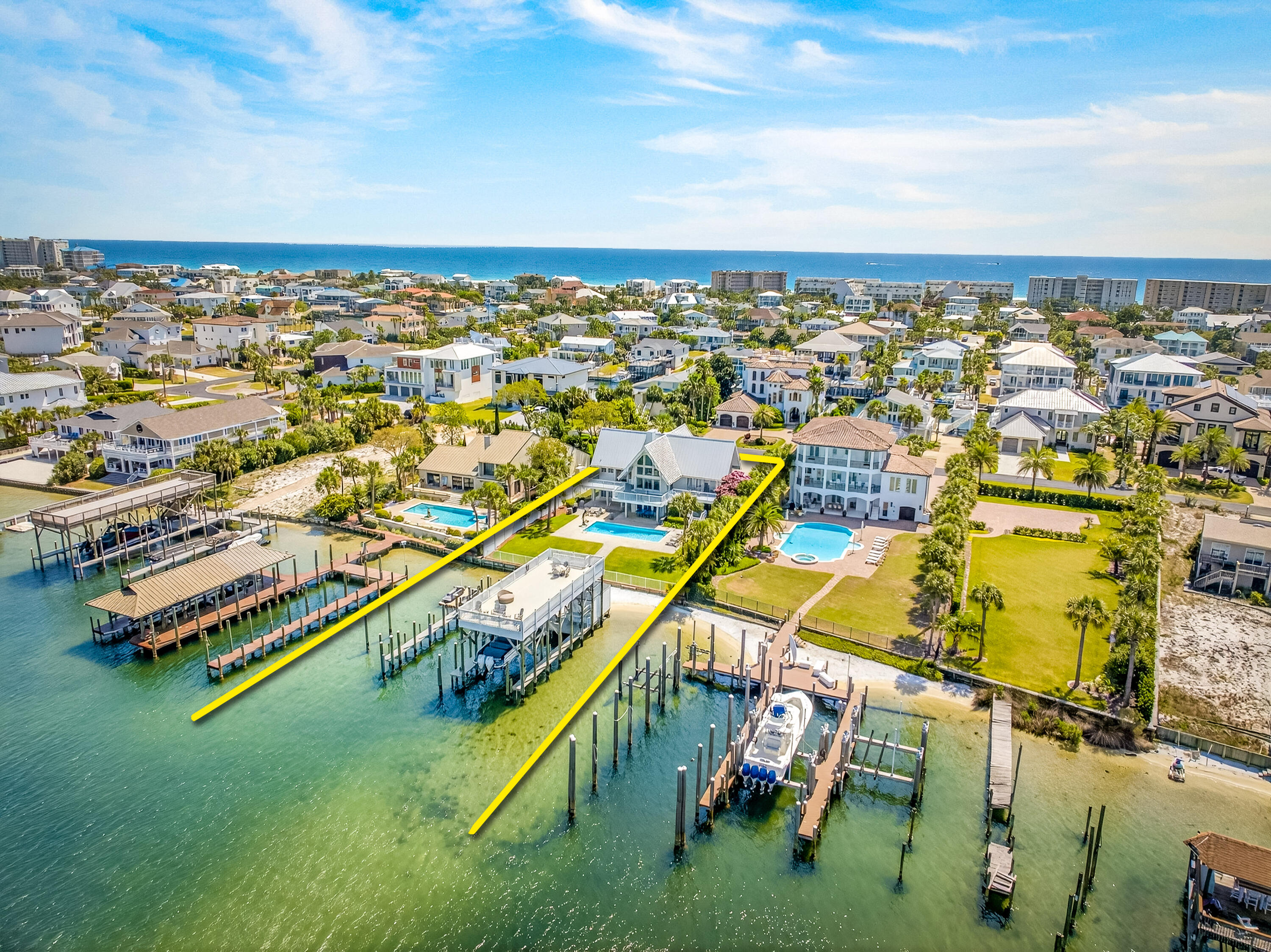 LIST PRICE REDUCTION! EXTRAORDINARY, DEEP-WATER, YACHTSMAN'S & SPORTSFISHERMAN'S WATER-FRONT ESTATE oriented on Destin, Florida's Scenic Harbor.  Located within the legendary enclave of Holiday Isle, this exclusive address is the only harbor-front estate currently offered for sale and rarely do like-kind opportunities arise on the South side of the gorgeous Harbor due to such a limited density of lots fronting the harbor. Holiday Isle is unique in that it offers dedicated beach access for its ownership and their guests, which is afforded through very reasonable dues, currently $495.00/annually.  An estate of this caliber and distinction should be viewed as a generational ownership opportunity, as the phenomenal lifestyle it offers is unrivaled anywhere along the Emerald Coast on the Gulf of America.  This property has been beautifully renovated and newly decorated and is being offered turnkey; fully furnished and accessorized with all audio and video.  The dock structure and its features are irreplaceable; "grandfathered" specifications, thus providing an instant solution to moor and lift your boats, yachts, skid for jet skis, paddleboards, tackle/storage room, motorized catch lift and guided aluminum rails to the fish cleaning station, and a magnificent rooftop sunbathing  and stargazing terrace atop two of the covered slips; all accessible directly from your private backyard, which includes an expansive heated pool.  The hardscaping, landscaping, and ambient exterior and dock lighting accentuate the distinctive roof and dock elevations. Quite a scope of improvements have recently been completed, including but not limited to the following: (2) natural gas Rinnai tankless hot water heaters that supply the entire house; all recessed lights throughout were replaced with efficient LED technology; entire interior repainted including all new moldings; exterior deck painted and sealed; all exterior railings painted; new insulated, modernized garage doors and openers; AquaLink technology that allows for control of the pool functions via smartphone app; Control 4 home automation app also interfaces with the TV's.  (2) new Trane A/C units installed; while all four units have new Trane thermostats controlled remotely via app; oversized double floating jet dock installed; (7) high resolution digital home surveillance cameras with cloud-based NVR; (4) boat dock Luma surveillance cameras.  Wi-Fi module added to the Generac whole house generator allowing for interface with a smartphone app as well. The most extraordinary dock, slips, boathouse, and boathouse rooftop terrace on Holiday Isle with spectacular view corridor of the scenic harbor and fabulous sunsets.  Please inquire for further details and to schedule a private showing.