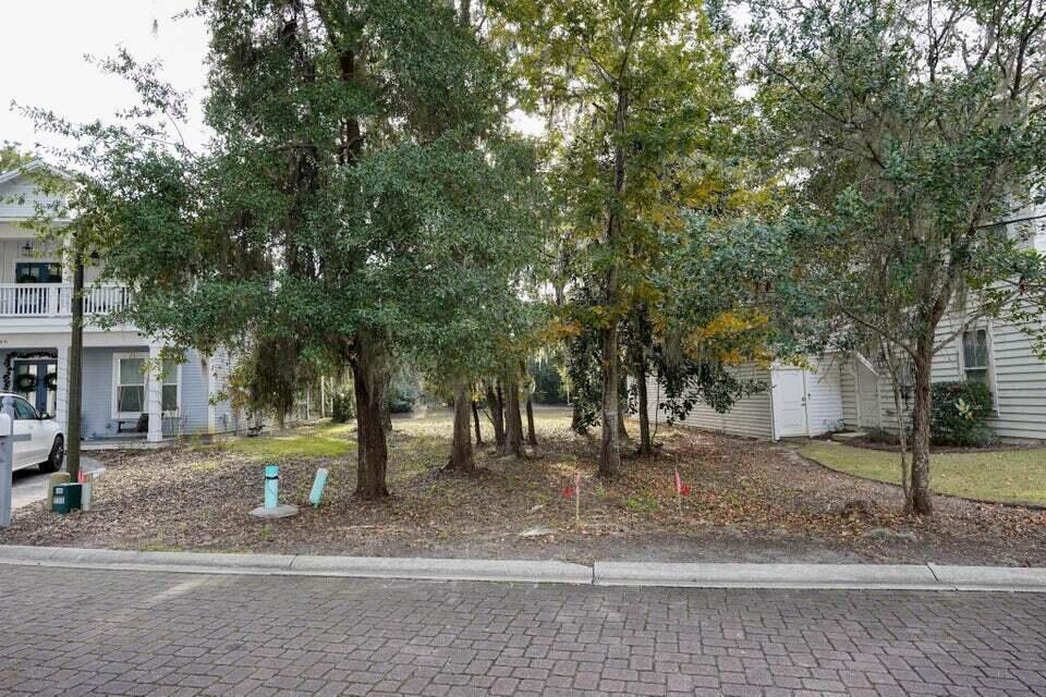 Beautiful Lot to Build your dream home in this quaintly developed neighborhood w/  dock. Waterview Lot (empty lot across the street)  in Sacred Oaks! Enjoy a tranquil setting with massive live oak trees, underground utilities, brick paver streets, and a community dock on Mack Bayou. There are no short term rentals allowed in Sacred Oaks and this lot backs up to a green space for additional privacy. The neighborhood is convenient to some of the areas best shopping and dining in nearby San Destin Resort and Grand Blvd. There are many public beach accesses within a few miles.\
Beautiful permitted house plans available , can be purchased w/lot