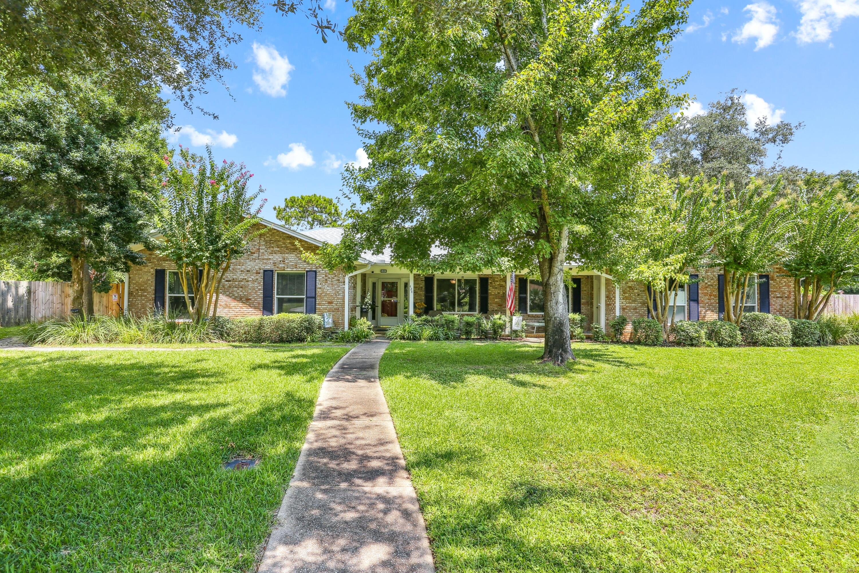 Rare income-producing or multi-generational layout in the absolute heart of Gulf Breeze Proper! This move-in ready, all-brick ranch features a highly versatile design offering a primary 3-bedroom, 2-bathroom residence on one side, and a fully self-contained attached 1-bedroom, 1-bathroom apartment, complete with its own kitchenette, full bath and private entrance & 2 car garage on the other side. Perfect as a high-yield rental space, guest house or independent in-law suite. The interior boasts gorgeous low-maintenance tile flooring throughout (zero carpet), an updated kitchen that seamlessly opens to a spacious living room centered by a cozy fireplace, and elegantly renovated bathrooms featuring custom designer tile finishes. Step outside to a private, beautifully landscaped outdoor oasis featuring a massive 18 x 18 screened porch overlooking your private in-ground pool. Massive structural & insurance-saving upgrades include: * Fortified Exterior: Impact-resistant windows and a 2021 shingle roof with hurricane clips, driving down insurance premiums. * No Flood Insurance required: located in Flood Zone X. * 2025 Major Mechanics: Brand new pool liner, new high-efficiency water heater, and a new sprinkler pump for the dedicated irrigation well (free lawn watering!) * Air Quality: Fully replaced ductwork integrated with an advanced UV light purification system. Situated in an unbeatable golf cart-friendly neighborhood with an A-rated school system! You are just steps away from Shoreline Park's boat ramp, fishing pier, and Gulf Breeze Rec Center, and only minutes from Pensacola Beach. Enjoy the ultimate blend of coastal convenience, community, and built-in equity!