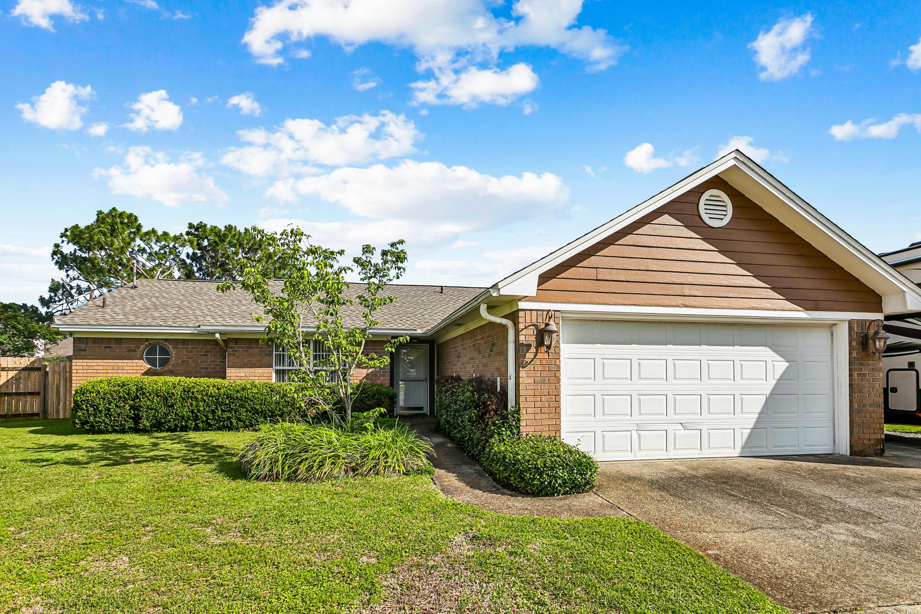 New PRICE! Make an appointment and come see this great home.  The main areas have beautiful, new paint (check out the photos). This well-designed home is located less than 8 miles from the Hurlburt front gate, and minutes from Navarre beaches and shopping. Use the light at HWY 98 and Whispering Pines to easily turn on to or cross HWY 98 for all your activities! The property features paid-off solar panels and geothermal heating and cooling systems, for eco-friendly and energy-efficient living-FPL bills under $50 per month! Enter the backyard through the enclosed porch that provides a cozy and protected area for relaxation and leads to the yard with  ample space for outdoor enjoyment and extra storage in the shed,  The interior of the home is well-maintained with upgraded kitchen cabinets and counters.  It also features a dedicated dining area, between the split bedroom layout for added privacy. The property has additional space for boat or RV parking and  a roomy two car garage with work areas and shelving ready for you! It is situated in a cul-de-sac, ensuring a quiet and private setting.