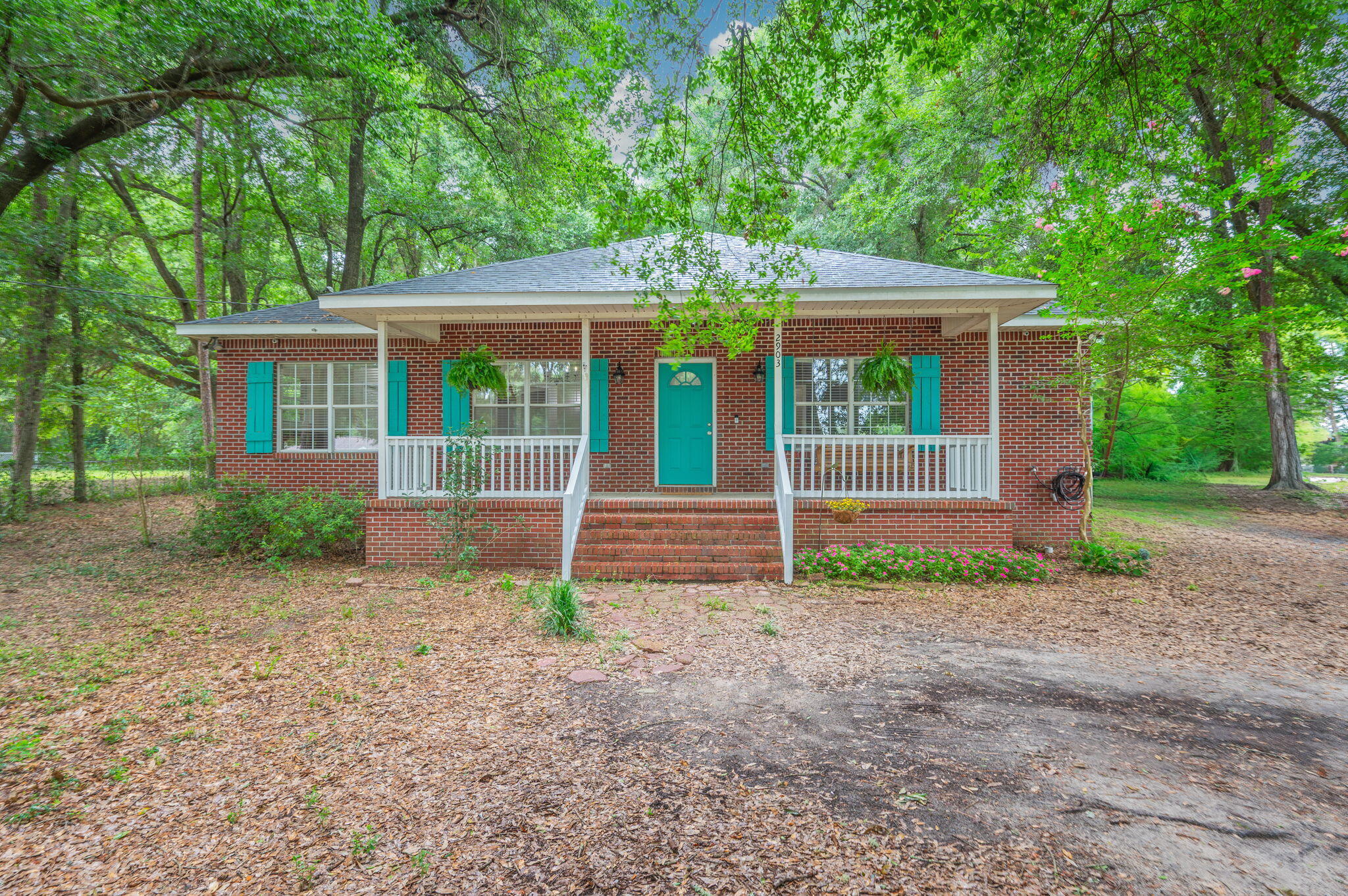 Get ready to fall in love with the space, privacy, and possibilities this beautiful all-brick home has to offer! Set on 0.7 acre lot, this property has so much potential and privacy! Porch swings, and hanging ferns grace the traditional front entry with a view of southern oaks.  Spacious floor plan featuring four bedrooms, two-and-a-half baths, and tile flooring throughout--no carpet anywhere! The oversized kitchen is luxurious with granite counters, NEW stainless appliances and recessed lighting.  Plenty of counter space, upgraded cabinetry, pull out pot drawers, a built-in trash, and room for everyone to gather and cook with both a kitchen island and built-in coffee bar. The kitchen has the added bonus of eat-in breakfast area with a picture window overlooking the beautiful front porch. Formal dining opens to the large living area. Wood-burning fireplace and vaulted ceilings are waiting for your giant Christmas tree. 10x11 foot indoor laundry room makes it easy to keep an extra freezer on-hand, or make a photo worthy mud-space. Extra large bedrooms in this split floorplan home, with closets everywhere!  Master is luxurious with separate oversized shower, garden tub, dual sinks, and a room-sized walk-in-closet. Bonus room is the perfect multi-use space and makes this home big on room! Outside, you'll appreciate the incredible privacy of the large fenced backyard, along with a spacious workshop that's perfect for hobbies, storage, or your next big project. Covered side parking adds even more convenience. Whether you're hosting barbecues, enjoying quiet mornings with a cup of coffee in the sizable covered back porch, or simply soaking in the peace and privacy, this home offers the space and lifestyle you've been looking for. Don't miss your chance to make this wonderful property your own. With updated major systems, you can move in with confidence and start enjoying everything this home has to offer. Roof was recently replaced with lifetime shingles in 2025, HVAC and Water heater are upgraded systems placed in 2020.