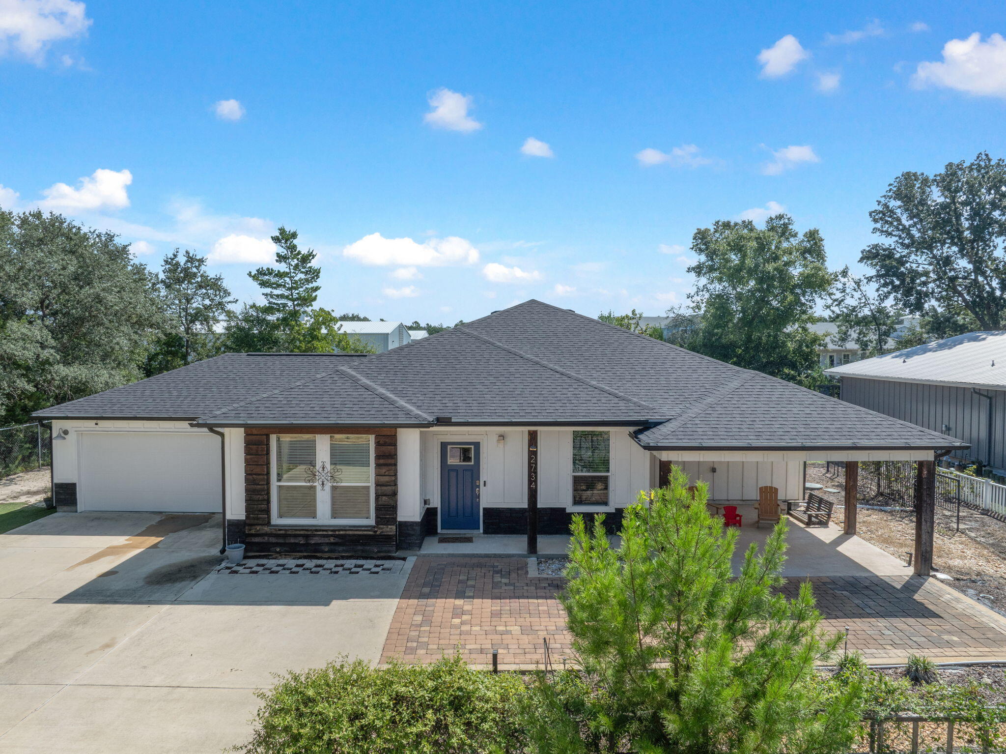 Welcome to this 2021 build 3 bedroom, 2 bathroom home in Navarre - perfectly located just minutes from shopping, dining, grocery stores, and of course the white sands and Emerald waters of Navarre Beach. With no HOA and proven success as a short term rental, this turn-key home is being offered fully furnished and is move-in-ready - perfect for investors to start earning immediate income, anyone looking for a second home getaway in Florida, or for a smooth and easy move for a first time homebuyer! Featuring an open concept Main living space and a split floor plan for maximum functionality. Complete with upgraded finishes such as LVP flooring throughout all common and wet areas, an elegant tray ceiling in the main living area, a beautiful chef's kitchen with center island with above pendant lighting, granite countertops, stainless steel appliances, plenty of gorgeous taupe cabinetry, and more! The oversized primary suite has its own ensuite with double vanity, tiled walk-in shower, separate soaking tub, and the most amazing oversized walk-in closet. Outside is built for entertaining - with an extended driveway and covered patio in the front of the house, as well as a covered patio in the backyard with an extended concrete pad that leads to the most awesome pole barn style outdoor bar/grill area with a covered firepit! With plenty of room left for a pool!