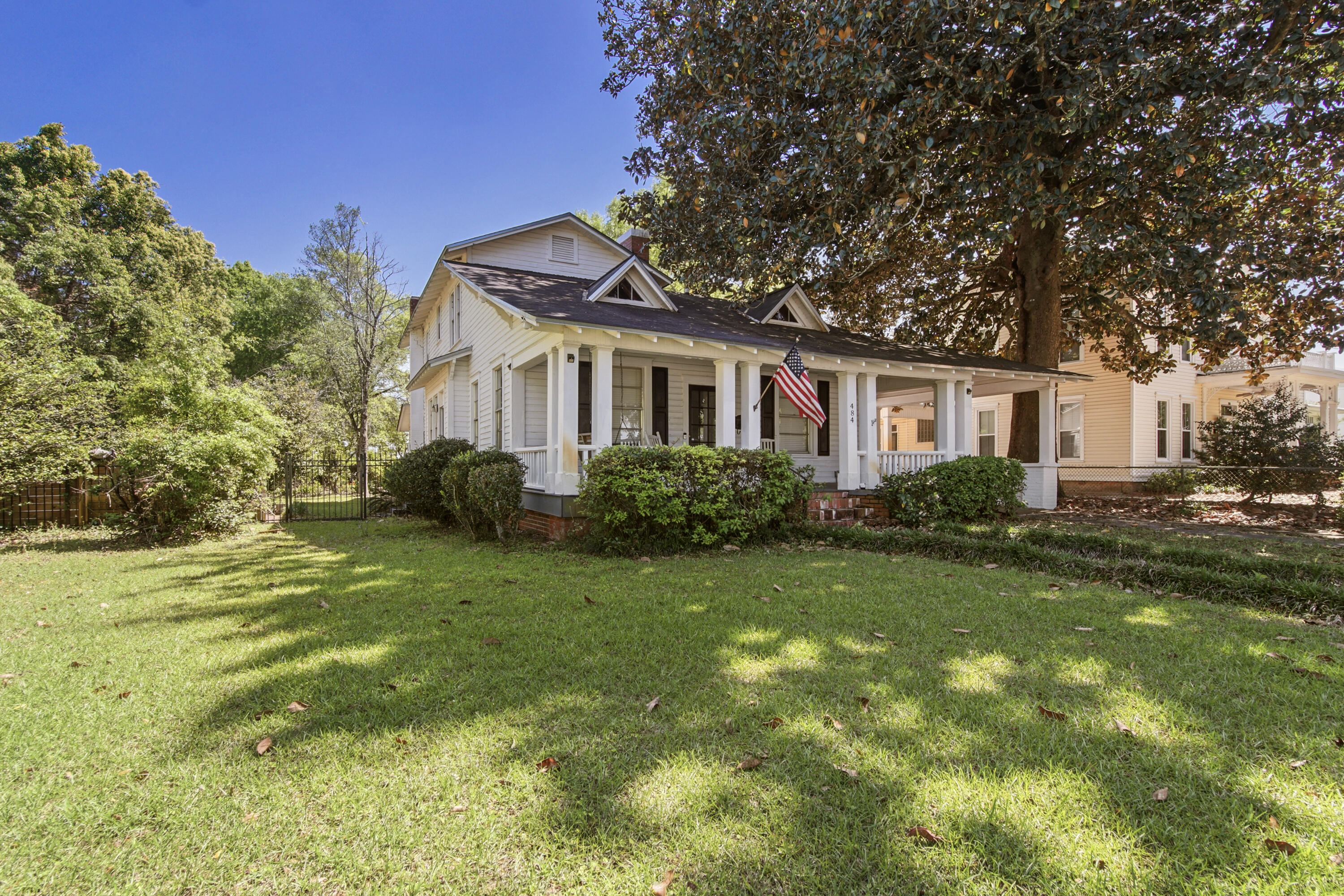 Circle Drive opportunities are rare, and this one puts you right in the heart of it. Set directly across from Lake DeFuniak, the views are front and center, with a porch made for slow mornings and golden hour evenings (think parades from your front porch!) Classic Craftsman style with two stories and a primary suite on the main level. Gorgeous hardwood floors with some updates completed and others ready for your personal touch. Fully fenced backyard with a brick patio with hot tub, plus a covered portico and access from both Circle Dr and Crescent. Walton Middle is practically across the street in the rear, and you're a short walk or golf cart ride to the lake yard, downtown events and all the hometown charm that keeps this area in demand. Embrace the quiet, small-town life right here.