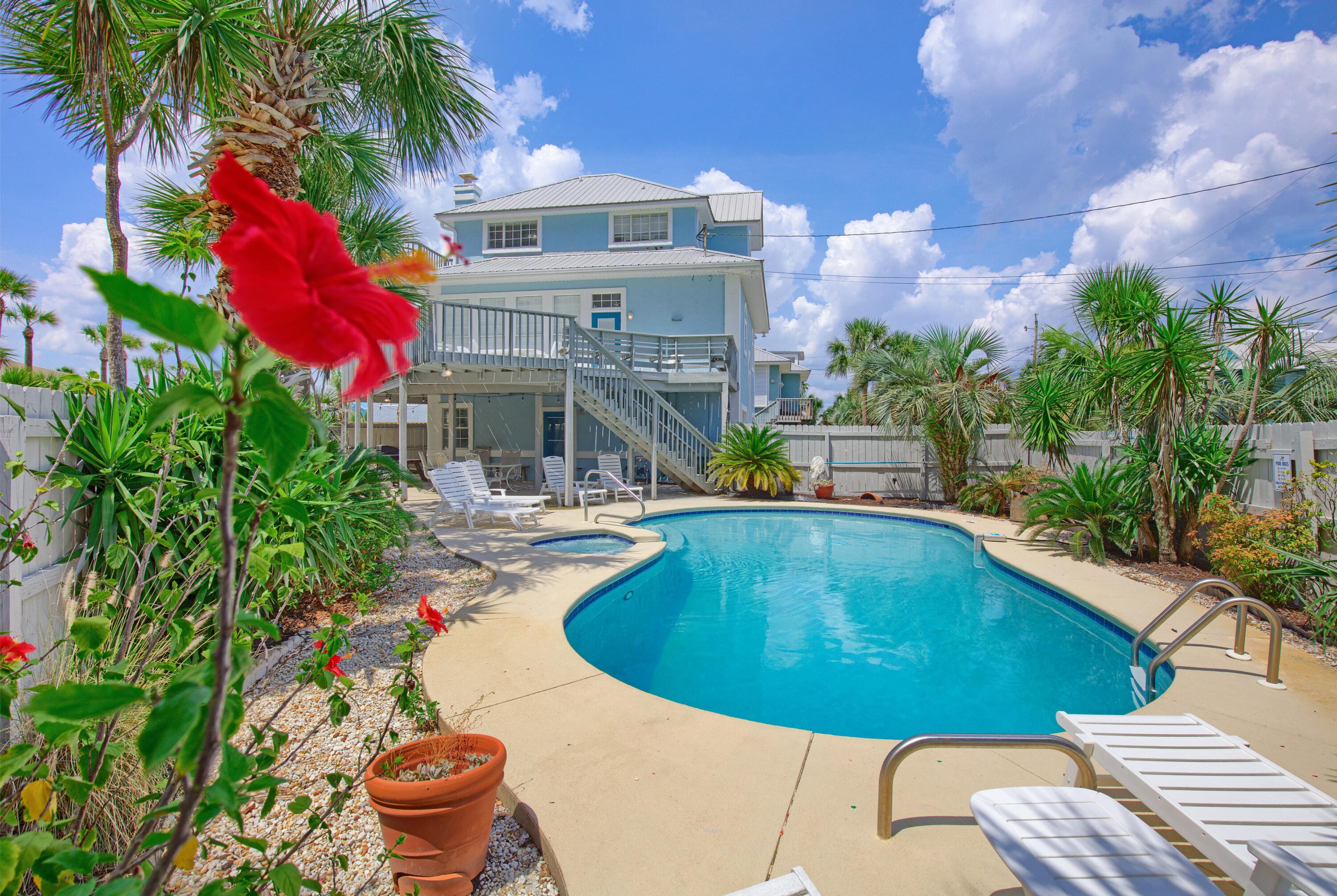 NEW PRICE AND MOTIVATED SELLER!  Fully- furnished, gulf-view home with private pool and literally just steps to the beach!  Situated on a private road with private beach access, this property offers a unique combination of privacy, convenience, and strong investment potential. This 4-bedroom, 3-bath home features a great layout for enjoying family and friends, an open kitchen, dining and living area, a 2nd living area located just off the pool, and an additional loft area that provides flexible space for guests or additional sleeping quarters. Enjoy gorgeous gulf views from your second and third stories, and a balcony on each level.  The second story balcony offers a spacious area with plenty of room to take in the breathtaking views and relax for family  meals, sunbathing, morning coffee, and evening sunsets.  The fenced backyard is designed for entertaining, and features a private pool and spa, pool deck, covered area to cool off in the shade, and grill space - this is the perfect spot to create new memories!  Ideally situated in Panama City Beach and within walking distance to local favorites including Finns, Liza's Kitchen, and Gypsea Crepes, as well as close to shopping, St Andrew's State Park, boating, and more.  Properties with these gulf views, private beach access, and private pool at this price point are extremely limited. Come make this your new primary residence, second home, or SHORT-TERM RENTAL INVESTMENT!  Schedule your private showing today!