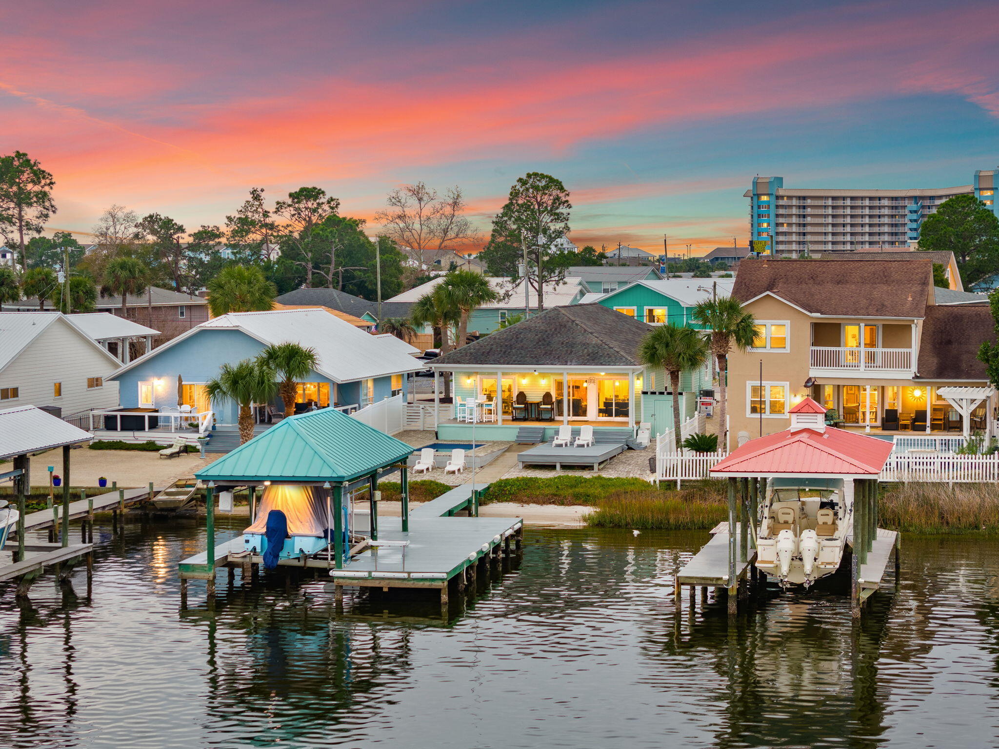 Set directly on Grand Lagoon, this thoughtfully maintained three-bedroom, two-bath residence offers 1,537 square feet of waterfront living with sweeping views and direct boating access to St. Andrew Bay and the Gulf of Mexico. Designed to make the most of its setting, the open-concept interior is filled with natural light and oriented toward the water, creating a seamless connection between the living spaces and the lagoon beyond.

Outdoor living is central to the property. Trex decking extends to a covered dock with a boat lift, while three nearby boat launches add convenience for days on the water. A heated and cooled pool provides year-round enjoyment, complemented by a paver driveway and low-maintenance Bahama rock landscaping.

Located just minutes from the beach, the residence is equally suited as a primary home, coastal retreat or short-term rental investment. Furnishings are negotiable, offering the opportunity for a streamlined transition into the waterfront lifestyle. With a private pool, protected dockage and convenient access to both the bay and Gulf, this Grand Lagoon residence presents an uncommon combination of comfort, recreation and location.

All information and measurements are deemed reliable but are not guaranteed. Buyers should independently verify all details.