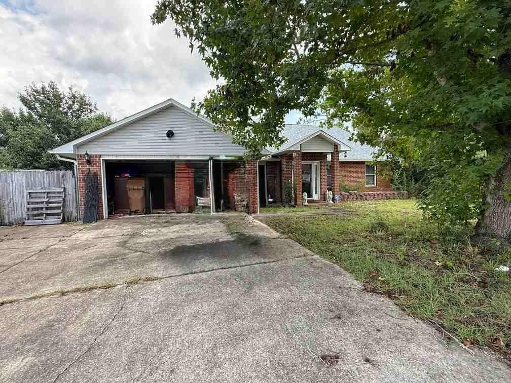 Investor opportunity in Navarre! This spacious 4-bedroom, 2-bath home offers approximately 2,101 square feet on an oversized 0.76-acre cul-de-sac lot. The functional split-bedroom layout features vaulted living areas, real hardwood and tile flooring, plus a kitchen with granite countertops, maple cabinetry and stainless steel appliances. Additional highlights include an enclosed Florida room, deck and pergola area, multiple storage buildings, and gated space for boat or RV parking. The roof is approximately one year old, while the HVAC is approximately 15 years old. The property presents a strong value-add opportunity with interior cosmetics, exterior cleanup and select repairs. Conveniently located near schools, shopping, medical services and Navarre's beaches. Property is offered as-is. Buyer to verify all measurements, features, permits and system ages deemed important.