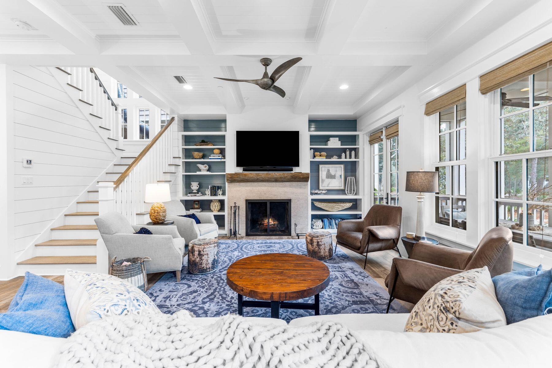Welcome to 79 Cedar Post Road in Draper Lake Coastal Village. Offering a comfortable lifestyle, this spacious home is all about versatility. It's perfect for larger families and those who love to entertain. It boasts a one-bed carriage house with a kitchenette and bathroom with its own independent access. The paver driveway leads up to a two-car garage and the entrance to this six-bed, five-bath home. The screened front porch is one of several outdoor living spaces and there are gulf views across the treetops from the top-floor balcony. The main house has myriad rooms and spaces that could efficiently be utilized as a bunk room, bonus room, second sitting room or home office. The grandeur of the living room immediately captures your attention, with a multitude of windows casting natural light across the generous space. The gourmet kitchen is fully equipped with a large island, quartz countertops, an impressive Thermador gas range, stainless appliances, beautiful lighting, pantry storage and tons of cabinetry beneath a lofty coffered ceiling. Real porcelain ceramic tile flooring and a sliding barn door add a touch of rustic charm. It flows naturally into a family dining area and a sitting room. Coastal decor complements the open fireplace, along with built-in shelving and a wet bar for entertaining. Doors open directly onto the screened porch. A spacious laundry room and a guest bathroom also occupy the first floor. The second floor has three bright bedrooms, with an additional bedroom on the third floor. The spacious master bedroom has its own generous balcony. It's the perfect place to start the day with a cup of coffee while listening to birds in the surrounding trees. The adjoining private bathroom has dual vanities, a walk-in shower, an oval soaking tub in the well-lit space. When it comes to recreational activities, it's hard to beat this coastal dune lake community. Fishing, hiking, kayaking and paddleboarding are on the doorstep and easy access to the beach and Draper Lake make swimming and sunbathing a breeze. Two boat houses, a lookout tower, two community pools and more are part of this gated community lifestyle, with 30A shopping and dining nearby.