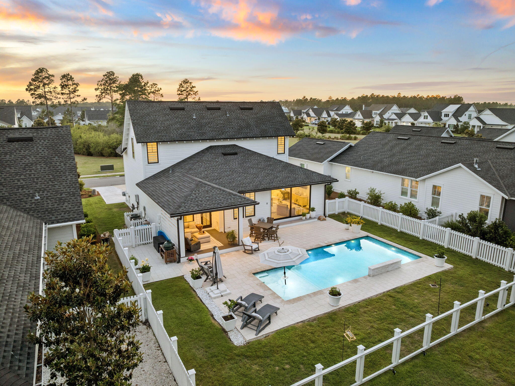 Set on a deep 133-foot lot with a private wooded preserve behind the home and a community green space directly across the street, this 2020 Huff Home offers something increasingly hard to find in Watersound Origins: no rear neighbors, and an open outlook in front instead of another roofline staring back at you. 

This Draper II plan opens through a wide sliding door in the main living area that frames the pool and preserve beyond. Outside, a 14x27 pool with a sun shelf anchors an expansive paver patio, set behind a privacy fence with mature pines rising past the back line. A screened porch with motorized screens - accessed off the kitchen - extends the living space and makes daily outdoor use practical year-round.

One of the highlights of the home is the kitchen - open, light, and positioned to take advantage of the pool view through the rear sliders. Quartz island, Bosch stainless, gas range, and wood cabinetry give it the kind of finish you'd expect at this price point without feeling overdone. Luxury vinyl flooring runs throughout, and the closets are built out across the bedrooms.

The floor plan puts the primary suite on the main level, with three more bedrooms and a second living space upstairs - a layout that works equally well for full-time families and for hosting guests. At 2,220 square feet, the home includes 4 bedrooms, 3.5 baths, and a 2-car garage.

Exterior details reflect the same attention throughout: heirloom brick, bronze windows, and rain gutters. Watersound Origins offers an unparalleled coastal lifestyle with access to a state-of-the-art fitness center, seasonally heated community pool, Lake Powell dock access with community kayaks and canoes, an executive golf course, tennis & pickleball courts, and miles of scenic trails. For the ultimate beach experience, owners can join the St. Joe Beach Club, unlocking private beach access, multiple pools, Gulf-front dining, and exclusive golf courses (Camp Creek, Watersound III & Shark's Tooth).

Ideally located just minutes from the new Publix town center, Scenic Highway 30A's top restaurants, boutiques, and year-round events, this one-of-a-kind property offers a rare opportunity for resort-style living in a prime location.