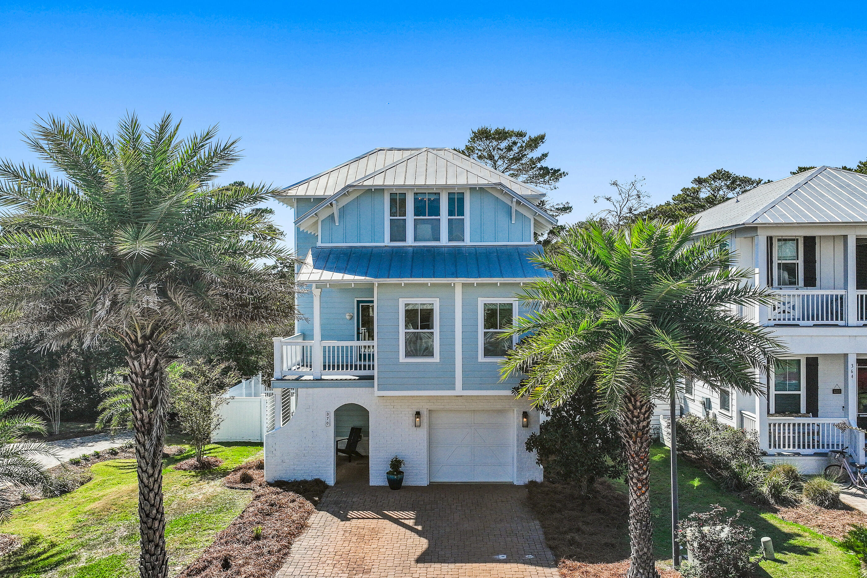 Golf Cart Included! Welcome to 370 Grande Pointe, an idyllic holiday home offering beautifully renovated interiors across three distinct levels totaling over 2,200 square feet of thoughtfully designed living space.

From the moment you arrive, the stately paver driveway framed by lush coastal landscaping sets the tone for this charming residence, highlighted by its freshly painted façade and inviting curb appeal. Inside, light-filled interiors and rich hardwood flooring create a warm and sophisticated atmosphere. The first floor living area provides exceptional flexibility, ideal for bunk space, a media room, or a potential fourth bedroom. Step outside to the expanded patio deck overlooking the serene preserve, where you can enjoy the ever-changing palette of the Emerald Coast's legendary sunsets. An outdoor shower is available and this level also features a private guest suite, full bath, and garage.

The second floor serves as the heart of the home, showcasing a newly refreshed gourmet kitchen complete with custom cabinetry, a luxury appliance package with gas range, and a spacious center island with integrated seating. The adjacent main living area is bright and airy, framed by a stunning wall of windows that captures the surrounding topography.  An additional guest suite and a beautifully renovated bath featuring a wet room design with floor-to-ceiling tile, freestanding tub, and rain shower complete this level.

Encompassing the entire top floor, the luxurious primary suite offers a true private retreat. The suite boasts custom tray ceilings, a dedicated office nook, and a spa-inspired en-suite bath with dual vanities, walk-in shower, and enclosed water closet.

Nestled between Lake Powell and the Gulf of Mexico, Grande Pointe is a tranquil coastal sanctuary. Residents enjoy access to a community pool, pavilion, and dock overlooking the rare coastal dune lake, Lake Powell, along with the convenience of a short walk to both the beach and lake. The community's prime location near the 30A Avenue commercial district, complete with an underground pedestrian tunnel to the 30A corridor, places acclaimed dining, shopping, and entertainment just moments away.

With projected annual rental income exceeding $55,000, this property presents an exceptional opportunity for investors or those seeking a second home or primary coastal residence. Furnishings negotiable. 

Schedule your private showing today and begin envisioning the coastal lifestyle you deserve.
