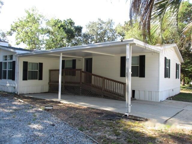 REO.  VA, Conventional financing okay.  Affordable Manufactured home in the heart of of Niceville located in a Mobile home park that also has a community pool and waterfront lake access.  Home has a living room with a fireplace and a family room.  Formal dining room and eat-in-kitchen as well.  Split bedroom design - Main Bedroom with bath is off family room.  Main bathroom features a garden tub and separate shower as well as double vanities.  A carport that will hold two cars.  There is also a screened porch off the kitchen.   This property is eligible under the Freddie Mac FirstLook Initiative through 10/23/2026. Homegenius Real Estate is Co-Broker