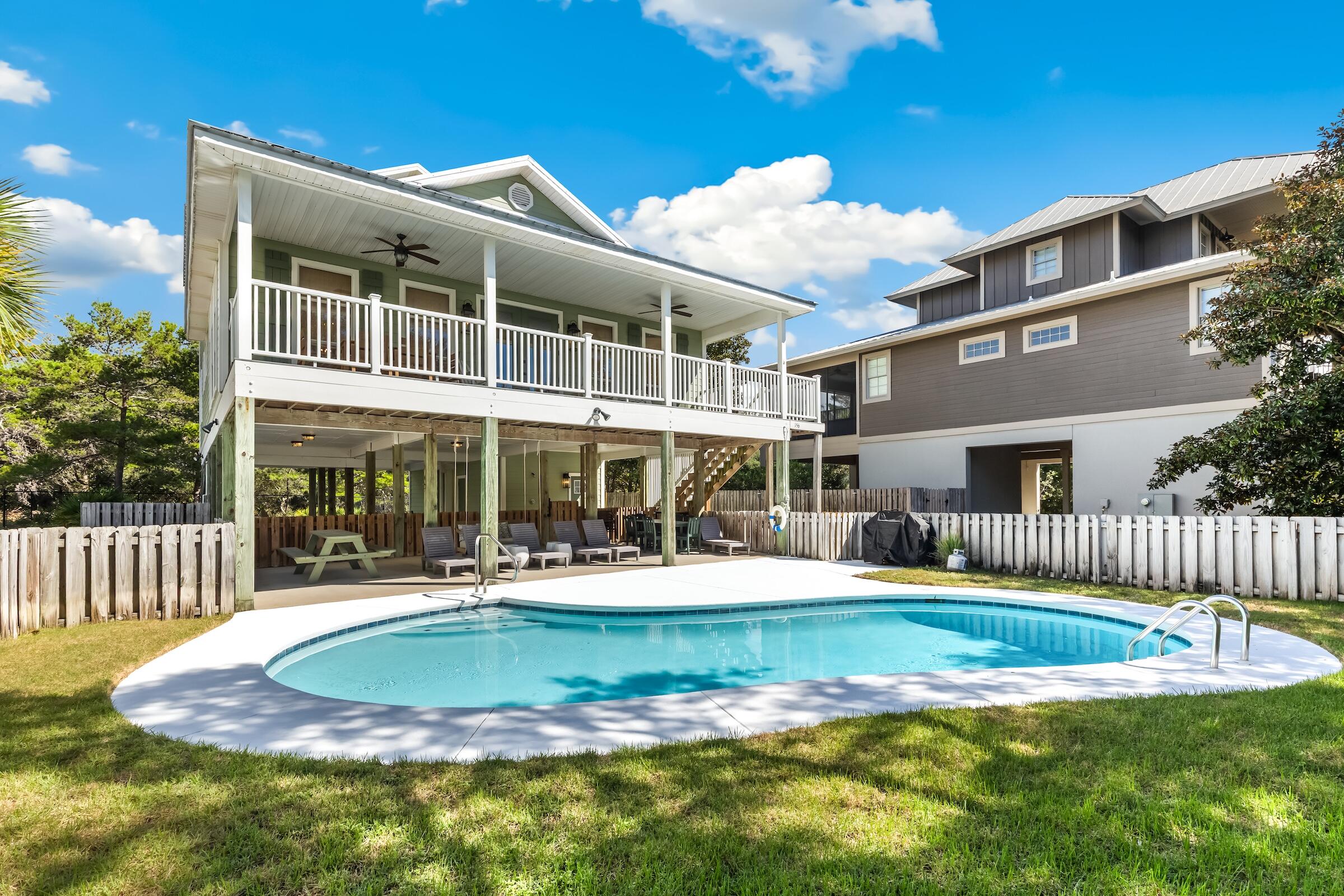 Discover a different side of 30A at 156 Savelle Drive, where the beauty of the coast is matched by an exceptional sense of privacy. Located in Gulf Trace, one of Grayton Beach's most distinctive residential communities, this beautifully updated four-bedroom, three-and-one-half-bath home offers a private pool, generous outdoor living and convenient access to the white sands and emerald waters of the Gulf. The setting is what instantly sets this property apart. Gulf Trace is surrounded by the natural beauty of Grayton Beach State Park, creating an environment that feels wonderfully removed while remaining convenient to the restaurants, shops and lifestyle of Grayton Beach and Scenic Highway 30A. Inside, the home is bright, comfortable and thoughtfully designed for coastal living. The main living level brings the kitchen, dining and gathering spaces together beneath vaulted wood ceilings, creating an open environment equally suited for quiet weekends at the beach or a house filled with family and friends. Natural light and carefully selected finishes give the interiors a relaxed sophistication without losing the casual character that makes a Grayton Beach home so inviting. Four bedrooms and four-and-one-half baths provide excellent separation and privacy for owners and guests, while additional bunk accommodations add flexibility for larger gatherings. A convenient first-level mudroom and laundry area provide a practical transition from days spent at the beach or beside the pool. Outdoor living is an important part of the experience. The private swimming pool offers a place to relax and entertain away from the crowds, while covered outdoor areas provide additional space to enjoy the coastal setting throughout the year. Ample parking for multiple vehicles is another valuable feature for a home designed to welcome family and guests. For those seeking the flexibility of rental income, the home's four-bedroom layout, private pool, beach access and highly desirable Grayton Beach location also offer compelling potential as a vacation rental. Whether enjoyed as a full-time coastal residence, a private second home or an investment property, 156 Savelle Drive provides the opportunity to tailor ownership to fit a variety of lifestyles. Perhaps most compelling is the opportunity to own within Gulf Trace itself--a neighborhood where beach access, protected natural surroundings and proximity to everything along 30A come together in a way that is increasingly difficult to find. 156 Savelle Drive is more than a beach house. It is an opportunity to enjoy Grayton Beach from a private enclave surrounded by some of the most beautiful coastal landscape in Northwest Florida.