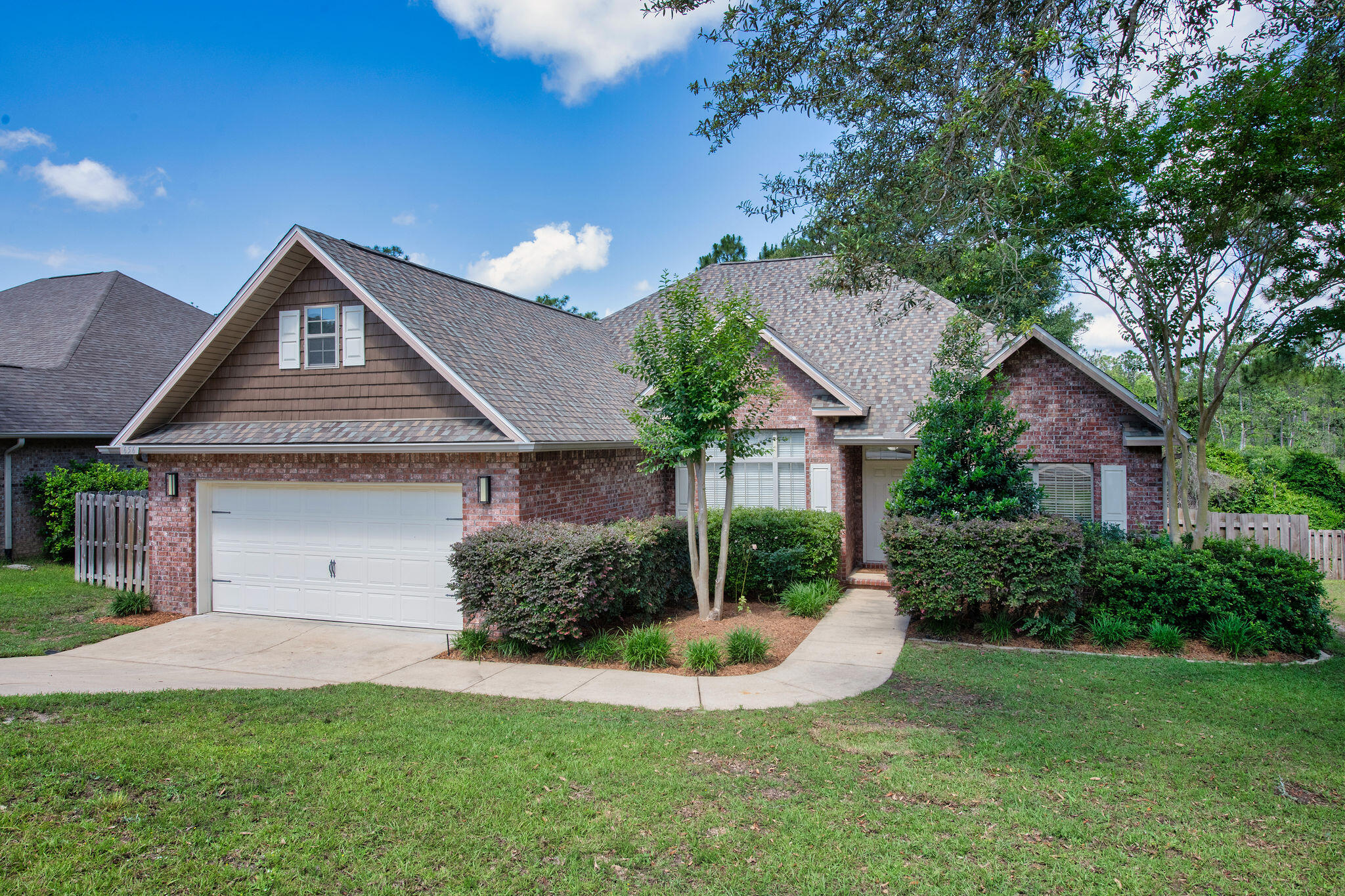 VA assumable loan available at an amazing 2.25% interest rate. Newer premium roof! This well-designed floor plan offers three bedrooms and two and a half bathrooms. The kitchen is thoughtfully appointed with black stainless-steel appliances, granite countertops, and a breakfast nook, making it both functional and inviting. A pantry with customizable shelving provides ample storage for dry goods and is a perfect place to store small countertop appliances. Spacious kitchen opens to the generous living room that offers wonderful views of the private woods behind the property. The primary suite is a true retreat with an extra-large walk-in closet, a dual vanity, a separate garden tub, and a walk-in shower. Split floor plan with large private master suite off the main living area and 2 additional bedrooms and full bath on the other side of the house, each with a spacious closet. Outside, the expansive backyard is fully privacy fenced and features mature blackberry bushes. Additional features and upgrades include a new Rheem HVAC system installed in 2021, a new GAF roof in 2024 with a 30-year transferable warranty, a Wayne Dalton insulated garage door and Fabric-Shield storm panels for inclement weather protection, as well as a separate irrigation line for the Rainbird sprinkler system. Wood grained, ADA-compliant, non-skid ceramic tile installed throughout the entire house in 2024. For added convenience, the washer, dryer, and refrigerator will convey with the residence. Low HOA fees include a beautiful playground area and maintenance of public areas. This neighborhood is minutes away from shopping via the new Crestview bypass, and also aligns to the new Pineview School, Crestview's brand-new K-8 school which opens in August 2026. Don't miss this wonderful opportunity for location, price and condition!