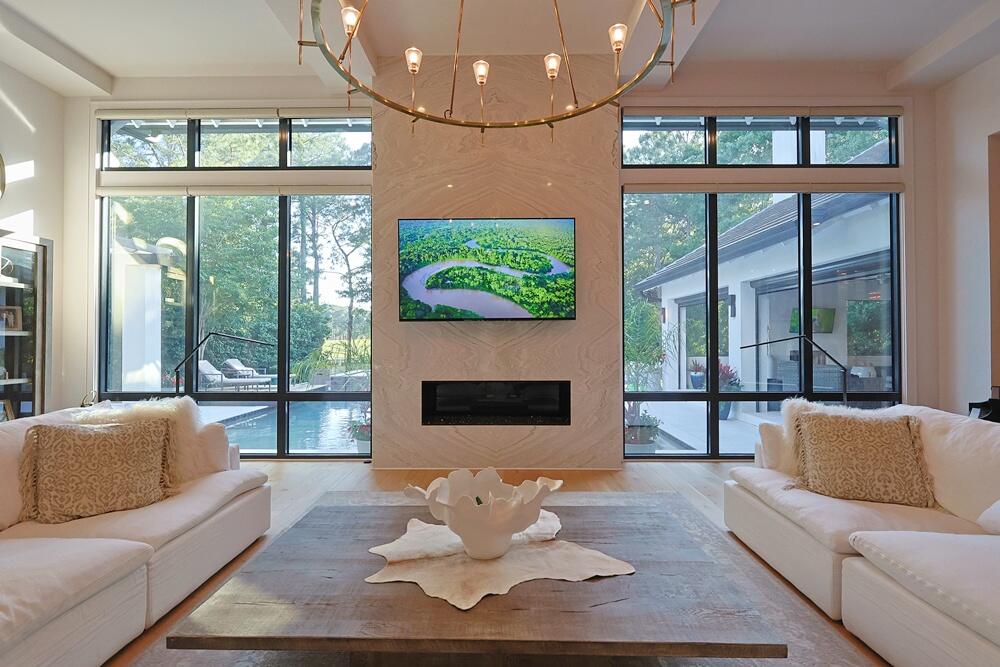 A double lot in the heart of Burnt Pine -- one of the few in the neighborhood -- sets this 2020-built contemporary apart before you even walk in. Two private garage-apartment suites, each with its own separate entrance, give guests, extended family, or staff true independence from the main house. Inside, soaring ceilings frame a chef's kitchen and a first-floor primary suite with fireplace and sitting area, while a home theater flows into the game room and out to nearly 700 square feet of enclosed, year-round outdoor living overlooking the pool, spa, and the 11th hole of the Burnt Pine golf course. Thanks to a lighter tree line than neighboring lots, this backyard also happens to be one of the few in Burnt Pine with a clear view of the summer fireworks. Offered fully furnished, with a number of features custom-built specifically for this home. A rare combination of scale, privacy, and setting -- even by Burnt Pine standards. Welcome to 3127 Merion Drive, a premier contemporary residence located within the exclusive Burnt Pine enclave of Sandestin Golf & Beach Resort in Miramar Beach, Florida. Positioned on a private cul-de-sac and backing to the golf course, this luxury property offers approximately 6,568 heated and cooled square feet on a .72-acre lot, delivering privacy, scale, and resort-style living.

This 4-bedroom, 5.5-bath home is thoughtfully designed with each bedroom offering a full ensuite bathroom, providing comfort and privacy for residents and guests alike. In addition to the primary living spaces, the home features three dedicated bonus rooms: a private theater room, a fully equipped exercise room, and a game room located just off the covered patio--creating multiple lifestyle and entertainment zones within the home.

The architectural design emphasizes clean modern lines, vaulted and beamed ceilings, and expansive natural light throughout. Multiple gas fireplaces anchor key living areas, adding warmth and ambiance. The chef's kitchen is centrally located and includes a large island with breakfast bar, premium appliances, wine refrigerator, pantry, and seamless flow into the main living and dining areas.

The first-floor primary suite is designed as a private retreat, featuring a sitting area, fireplace, huge walk-in closet, and a spa-style bathroom with double vanity, soaking tub, and separate shower complete with steam room.

Outdoor living is a defining feature of this property. The oversized covered patio functions as a true year-round living space, ideal for dining, relaxing, and entertaining. This area transitions effortlessly to the secluded backyard with a heated pool, hot tub, cabana, and fenced yard--all overlooking the Burnt Pine golf course and is home to breath taking sunsets.

Additional features include a 3.5-car garage with golf cart parking, partial furnishings for convenience, and access to Sandestin's full suite of resort amenities including beach access, marina, golf, tennis, pickleball, and more.

Located in Walton County within close proximity to dining, shopping, and the Emerald Coast's white sand beaches, this home offers a blend of modern design, privacy, and resort lifestyle living.

Keywords:
Burnt Pine home for sale, Sandestin luxury home, Miramar Beach golf course property, Walton County luxury real estate, contemporary home Florida Gulf Coast, Sandestin Golf and Beach Resort property, Northwest Florida luxury home, gated golf community home Florida, resort lifestyle home Miramar Beach, modern home with pool Sandestin, indoor outdoor living luxury home, South Walton real estate listing, Emerald Coast luxury real estate, golf course home Florida Panhandle, large luxury home Sandestin, 6500 square foot home Florida, upscale Miramar Beach property, Burnt Pine real estate listing, Sandestin resort living home.

Compliance Note:
Buyer to verify all dimensions, measurements, and information deemed important. Information is believed to be accurate but not guaranteed.