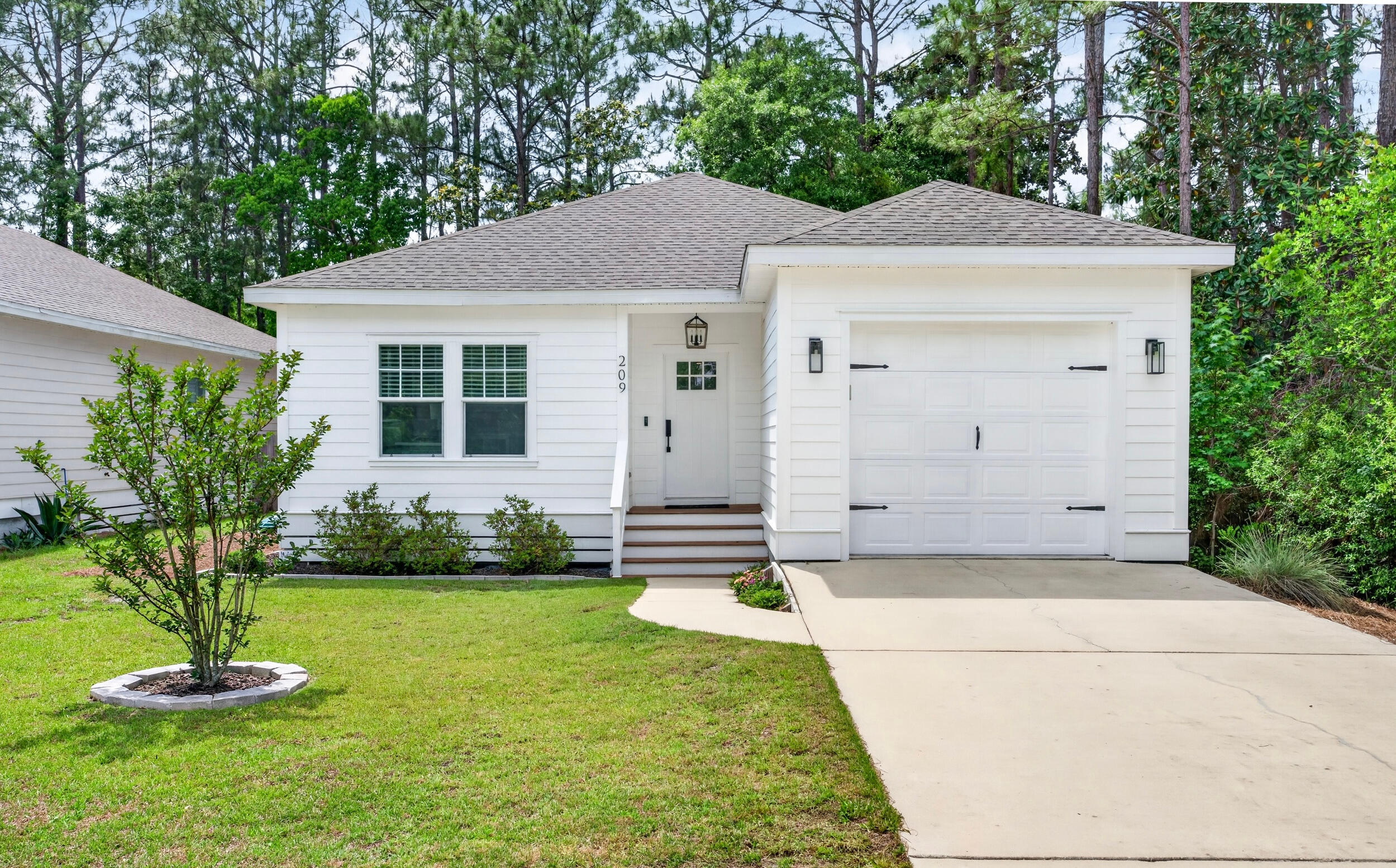 Bright, airy, and thoughtfully designed, this newer construction coastal-inspired 3BR/2BA home in Santa Rosa Beach offers an inviting open layout with $70K in upgrades and custom finishes. Shiplap accents, nine-foot ceilings, and luxury vinyl plank flooring create a light and relaxed feel, while the custom floor-to-ceiling built-in bookcase with electric fireplace adds warmth and character to the living space. The kitchen features quartz countertops, marble backsplash, oversized island, vent hood, and custom cabinetry extended to the ceiling. Additional highlights include a one-car garage, new exterior paint (2024), and no HOA or rental restrictions, offering added flexibility for full-time living, a second home, or investment potential. Conveniently located near Cessna Landing and just 10 minutes from 30A and Ed Walline Beach Access.