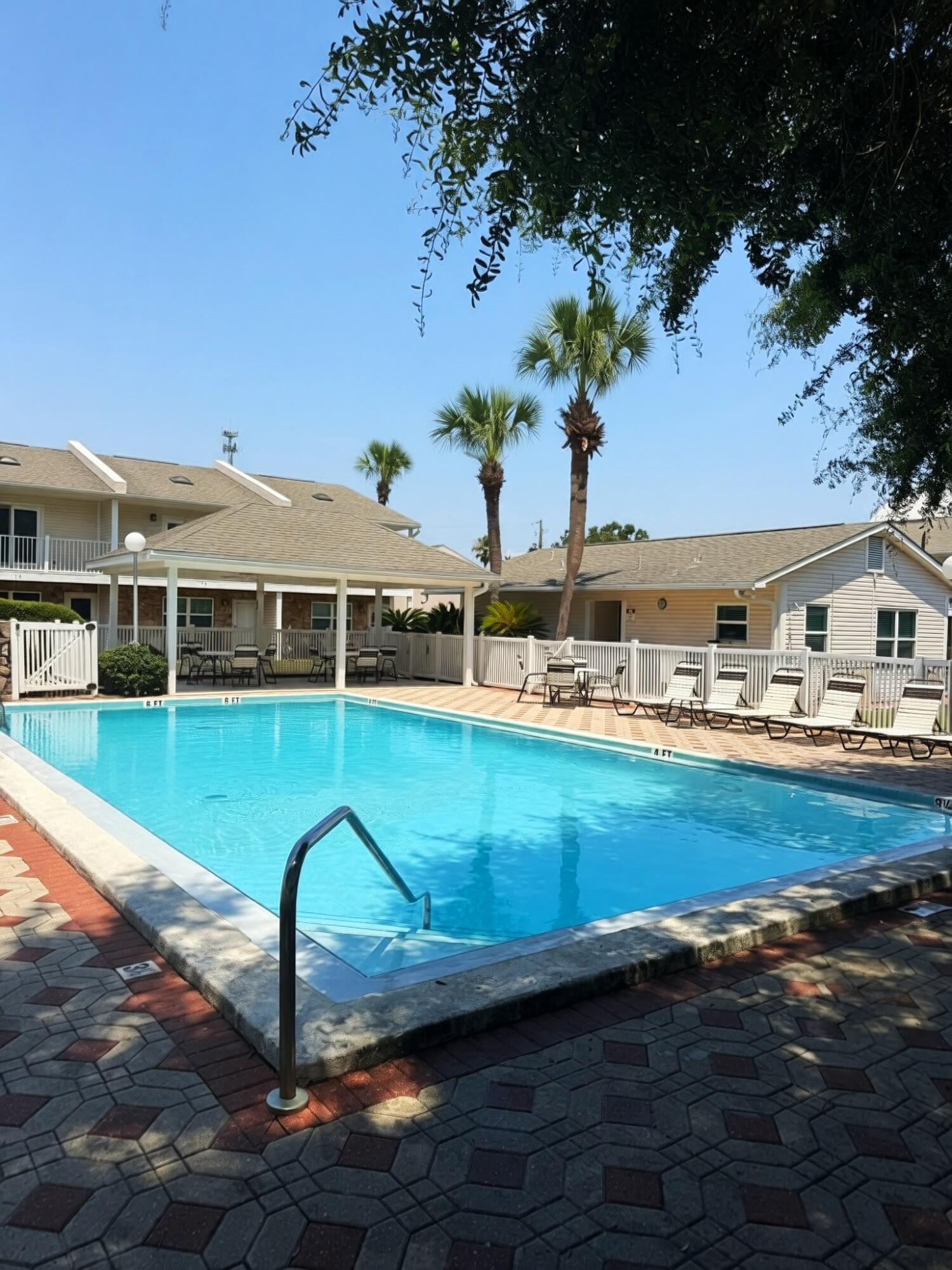 MOTIVATED SELLER- BRING OFFER. Walk to the beach from this charming 2-bedroom, 2.5-bath townhome in Woodland Shores! Ideal as a primary residence, vacation getaway, or investment property. The open main level features a spacious living area, well-equipped kitchen with abundant cabinetry and counter space, half bath, laundry, and a private patio with outdoor storage. Upstairs, both bedrooms have private baths, and the primary suite opens to its own private balcony. Enjoy two community pools, two reserved parking spaces directly outside your front door, and a prime location just minutes from the beach, restaurants, shopping, and entertainment