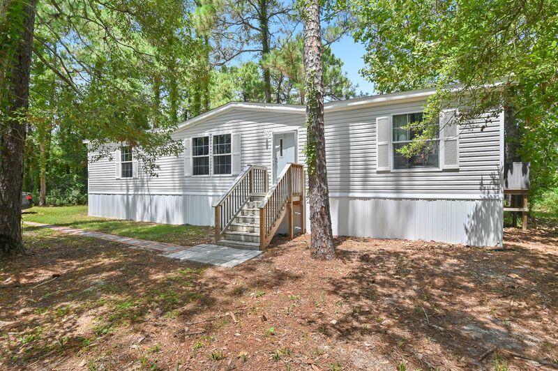 Owner Relocating! Discover 122 Nikki Circle, a 2022 double-wide home on a spacious 0.44-acre lot in Santa Rosa Beach. This 1,512-square-foot home features an open-concept layout, kitchen island, dedicated laundry room, and a modern split floor plan with 3 bedrooms and 2 bathrooms. The wooded setting offers ample parking for up to six vehicles. Enjoy convenient access to Choctawhatchee Bay less than one mile away at the updated Kellogg Bayside Park, with paddleboard and kayak launch options. Cessna Landing, with public boat launch and large docks, is less than two miles away, and Ed Walline Beach Access on 30A is just 3.5 miles from home, leading to the Gulf's beautiful white-sand beaches and emerald waters. A MUST SEE!
