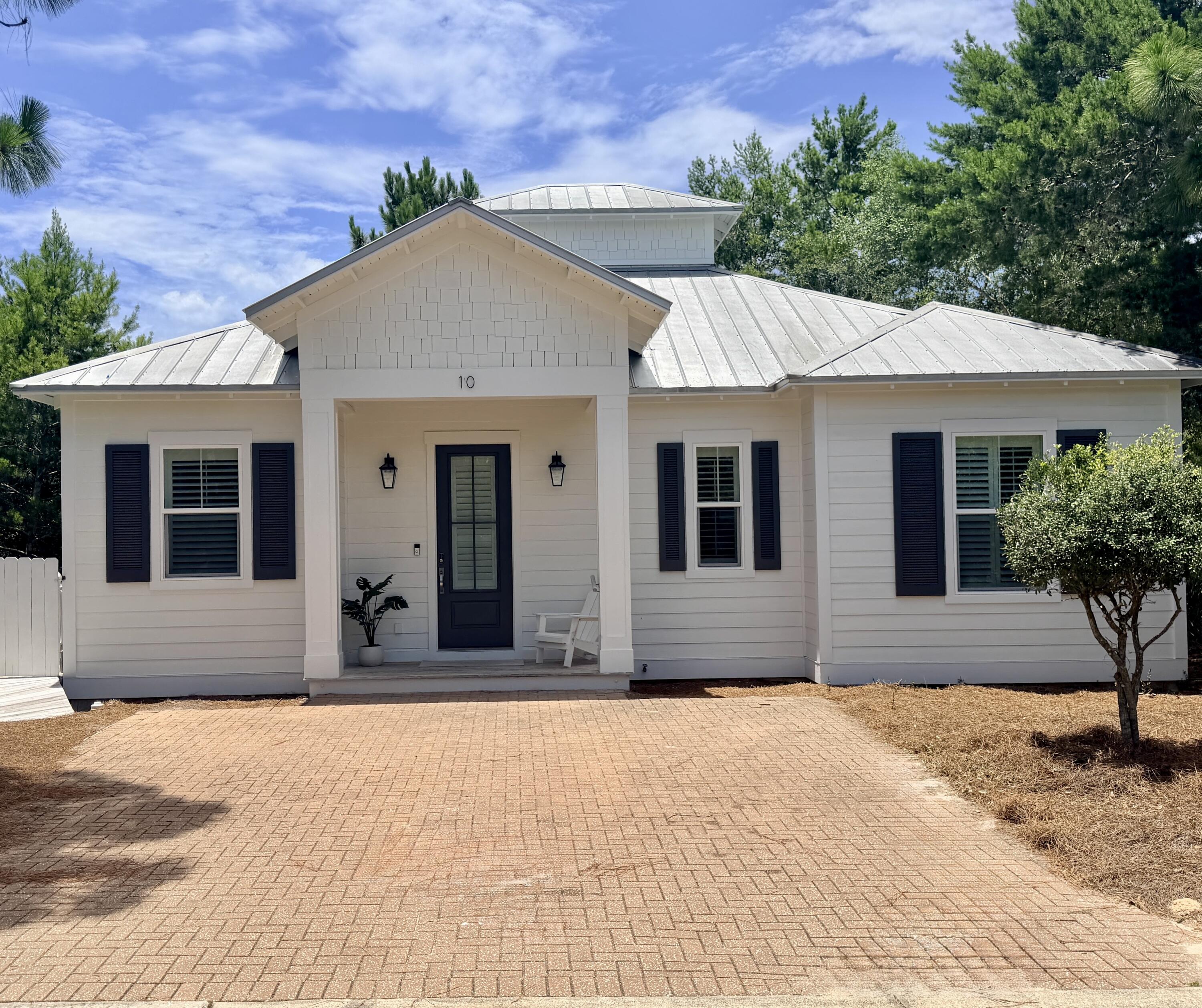 Look who's sporting a fresh new glow! This 30A beauty just leveled up with a crisp exterior paint job (Summer 2026) and chic new lanterns to light your way home. Perched on a generous corner lot in one of the most coveted beach communities, this turnkey cottage is the ultimate coastal retreat. You're just moments away from the sugar-white sands and the vibrant dining scene that makes 30A legendary. Ready to move in and start living the beach life? She's officially ready for her close-up.