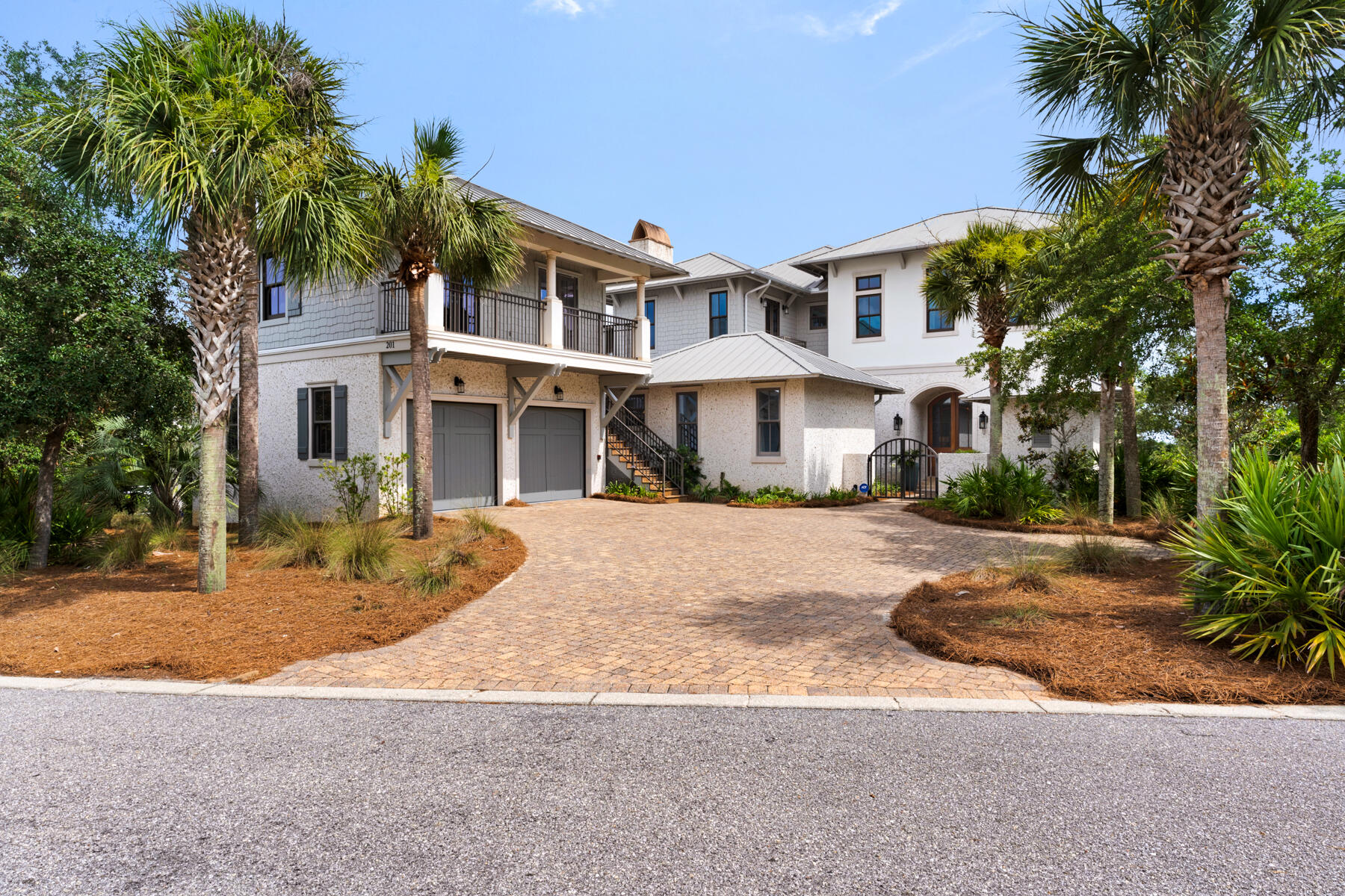 201 Bermuda Drive is located in the exclusive private gated neighborhood of The Retreat on 30a. Incredible views of both the Gulf and Draper Lake merges the outdoor beauty with that of the interior beauty consisting of custom fine finishes, high ceilings, pleasant decor, and natural light. Home has a total of 8,243 sq.ft. consisting of 5,558 sq.ft. of heated/cooled space, balconies, and an outside sitting area with fireplace and conveys furnished. The heated/cooled spaces consist of the main house, a detached one-bedroom guest quarter, and separate Carriage House. The welcoming foyer opens to the second level of the home with an open floor plan consisting of the gourmet kitchen, gathering room with fireplace, balcony, half bath, and laundry area. Take the elevator or stairway to the 3rd floor or the ground. Out the kitchen door is the outdoor sitting area with fireplace, entry to the one-bedroom separate guest quarter with private bath, grill area, and exit to fenced yard. The outside staircase leads to the charming Carriage House with bedroom, bath, kitchen and sitting area. The third floor hosts the spacious master bedroom suite with sitting area, master bath suite with oversized walk-in shower, large walk-in master suite closet, and the 3rd floor balcony. The 3rd floor also contains a guest room with full bath, a sitting/break area with fridge and sink and a viewing balcony, and the 3rd floor laundry area. Ground Floor opens to the sitting area and boasts two bedrooms with Jack and Jill bath, ½ bath, and exit to the pool area. The property is fenced and is excellent for the family dogs to visit the outdoors. Exterior features of the home include coquina shell stucco, decorative fencing, pool area, landscaping, and an outdoor courtyard shower after a day on the beach. The home is just steps away from The Retreat's private beach and Coastal Dunes. The Retreat is a non-short term rental community with a guarded gated entry, a luxury community pool and clubhouse area overlooking the beautiful 30A beaches, and of course near 30A restaurants, biking, shopping, and golfing. Buyer to verify all dues and dimensions.