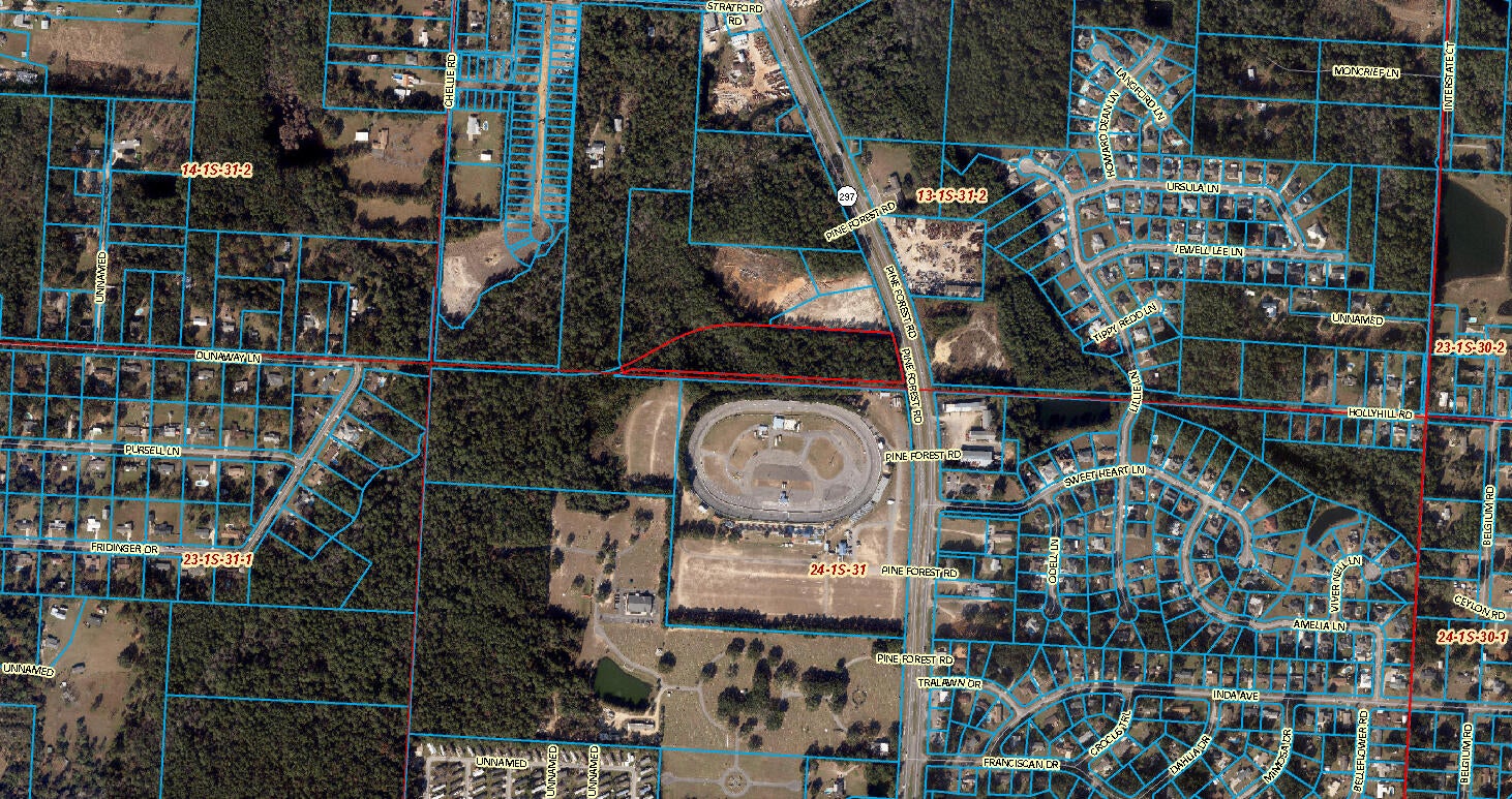 Bring all offers!!! Approximately 7.62 +/- acres zoned commercial with approximately 232 +/-  feet of highway frontage on Pine Forest Rd adjoining Five Flags Speedway. Prime location with close and easy access to Interstate 10. Property sits at the top of a hill on a curve in the 4 lane highway with very high visibility and tons of potential. Located just outside the city limits and a perfect location for a wide variety of businesses. Approximately half the property is designated wetlands per county site at the very rear of the property and has mitigation potential, but the roughly 3 +/-  acres in the front adjoining Pine Forest is 'high and dry.' and on a small hill. Huge development potential with an amazing location to invest in. The property lies just North of the racetrack just a few minutes from I-10 and major shopping on Nine Mile Rd. Only 11/12ths interest is listed offered as part of this listing. Mineral rights do not convey.