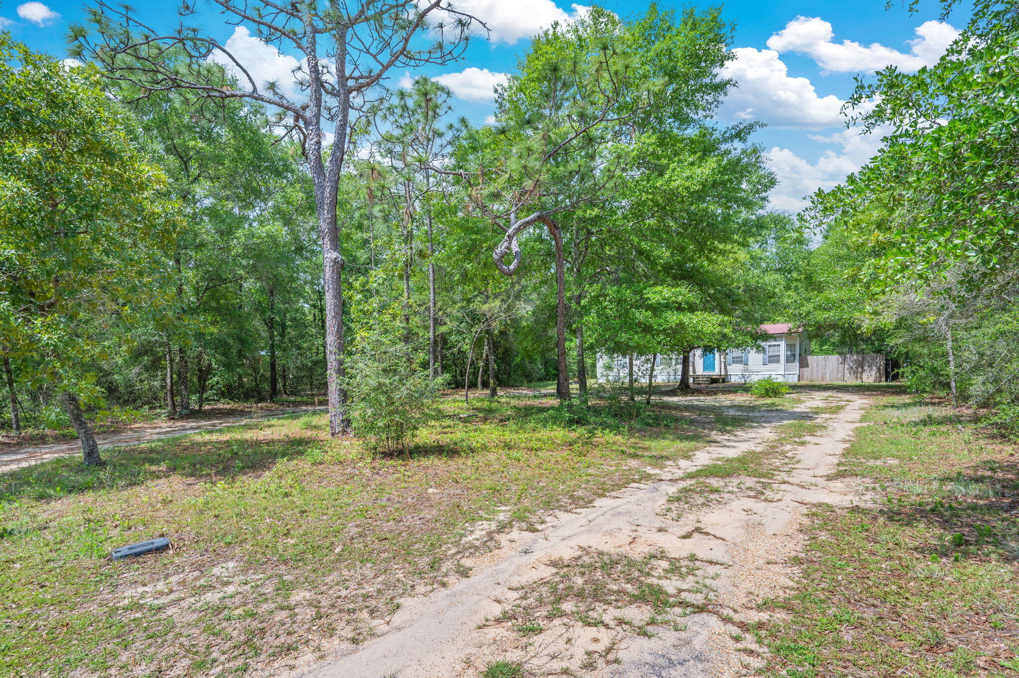 Tucked away in West DeFuniak yet conveniently located just minutes from town, this charming 3 bedroom, 2 bathroom manufactured home offers the perfect blend of privacy and accessibility. Sitting on a spacious .39 acre lot with the home positioned toward the back of the property, you'll enjoy a peaceful setting with a welcoming drive in approach that gives the property a true homesite feel.
Inside, you'll find a desirable split bedroom floor plan paired with a large open living area that creates the perfect space for relaxing or entertaining. New flooring throughout gives the home a fresh updated feel, while the durable metal roof adds peace of mind for years to come.
Whether you're looking for a primary residence, investment property, or a quiet escape still within reach of everything, this location is hard to beat -- approximately 10 minutes to town and only 45 minutes to the beautiful Emerald Coast beaches.