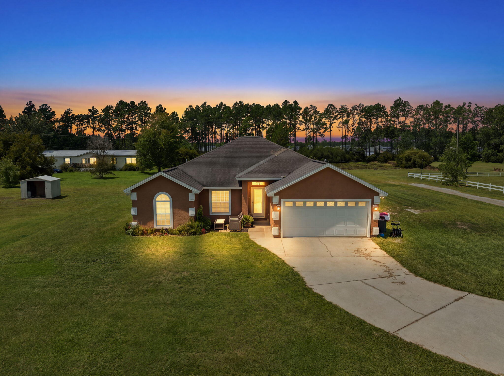 Set on approximately 11 acres, this 4-bedroom, 2-bath home offers the kind of space that can be hard to find without feeling completely removed from everything. Open fields, fenced and cross-fenced pastures, a pond, mature trees, and wooded areas create a setting that feels private and peaceful, while neighbors are still close enough to maintain a sense of community.

The property is already set up for horses and cattle, with a barn featuring stalls, air conditioning room for horse equipment, a new horse stall with special flooring, additional storage, and a large covered area with plenty of room for RVs, farm equipment, and everything that tends to come along with having acreage. New horse-appropriate grass planted in the fenced fields. The current tenant is using home as a horse ranch. Inside, the 1,690 SF home feels bright, comfortable, and connected to its surroundings. New flooring, new front and back doors. New The kitchen features new appliances, granite countertops, abundant cabinetry, and a breakfast bar opening toward the living area, while a separate dining space is surrounded by windows looking out across the property. The primary bath includes new double vanity, tiled walk-in shower, generous storage, and a large garden tub for relaxing.

But some of the best living happens just outside the back door. The oversized screened patio with new screens looks across the open fields, with room to gather, have dinner, stretch out in a hammock, or simply sit for a while as the sun goes down. With 11 acres to roam, room for animals and equipment, and a home that feels comfortable at the end of the day, this is a property designed to be lived on, not just lived in.
