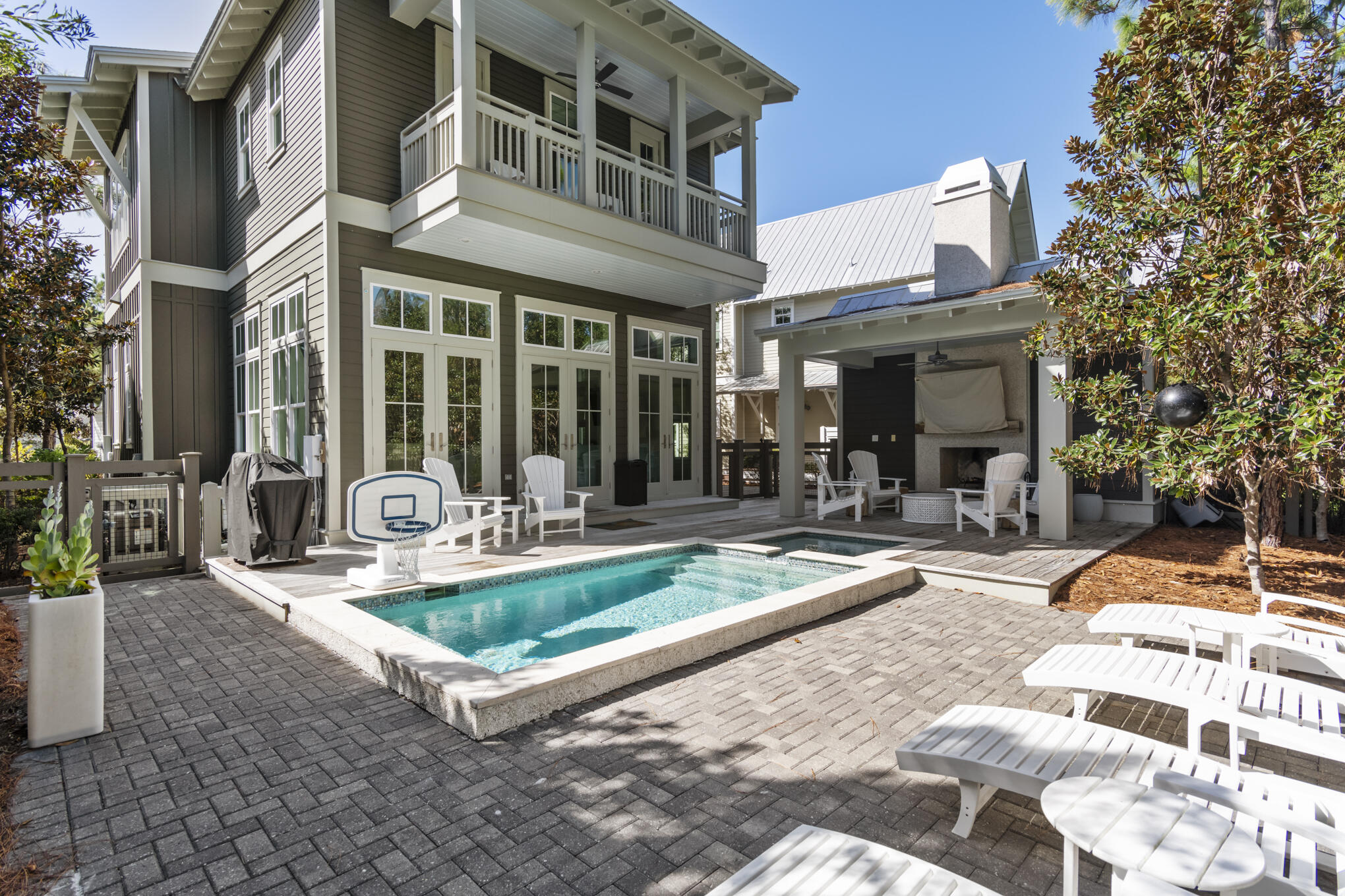 Tucked away in one of WaterColor's most desirable settings, 87 Sunflower Street offers a refined take on coastal luxury with exceptional privacy, backing to peaceful woodlands. Built by Romair in 2015 and thoughtfully updated in 2022, this 4-bedroom residence blends timeless architecture with fresh, high-end finishes and effortless indoor-outdoor living.

The light-filled main level showcases soaring 12-foot ceilings, floor-to-ceiling shiplap, and three sets of French doors that open seamlessly to a beautifully designed outdoor retreat complete with a private pool, hot tub, and fireplace--an ideal setting for entertaining or relaxing after a day at the beach.

The chef's kitchen has been completely reimagined with custom cabinetry, an oversized white quartz island, and premium appliances including Sub-Zero and Wolf, along with a separate cabinet ice maker and beverage cooler. A spacious first-floor primary suite offers a spa-like bath with a freestanding tub and Carrara marble walk-in shower, creating a true retreat.

Upstairs, a generous landing provides flexible space for a sitting area or office, leading to a second primary suite with a private porch overlooking the pool.  The primary suite has a Tub and separate shower. Two additional guest bedrooms, each with ensuite baths, include one with access to a large screened porch featuring a charming porch swing.

Offered fully furnished this home presents an exceptional opportunity as a primary residence, second home, or investment property with strong rental potential.

Ideally located just moments from the WaterColor Beach Club, Camp WaterColor, and the Frog and Dragonfly pools--and a short stroll or bike ride to Seaside's renowned dining and shopping--this home captures the very best of the 30A lifestyle.