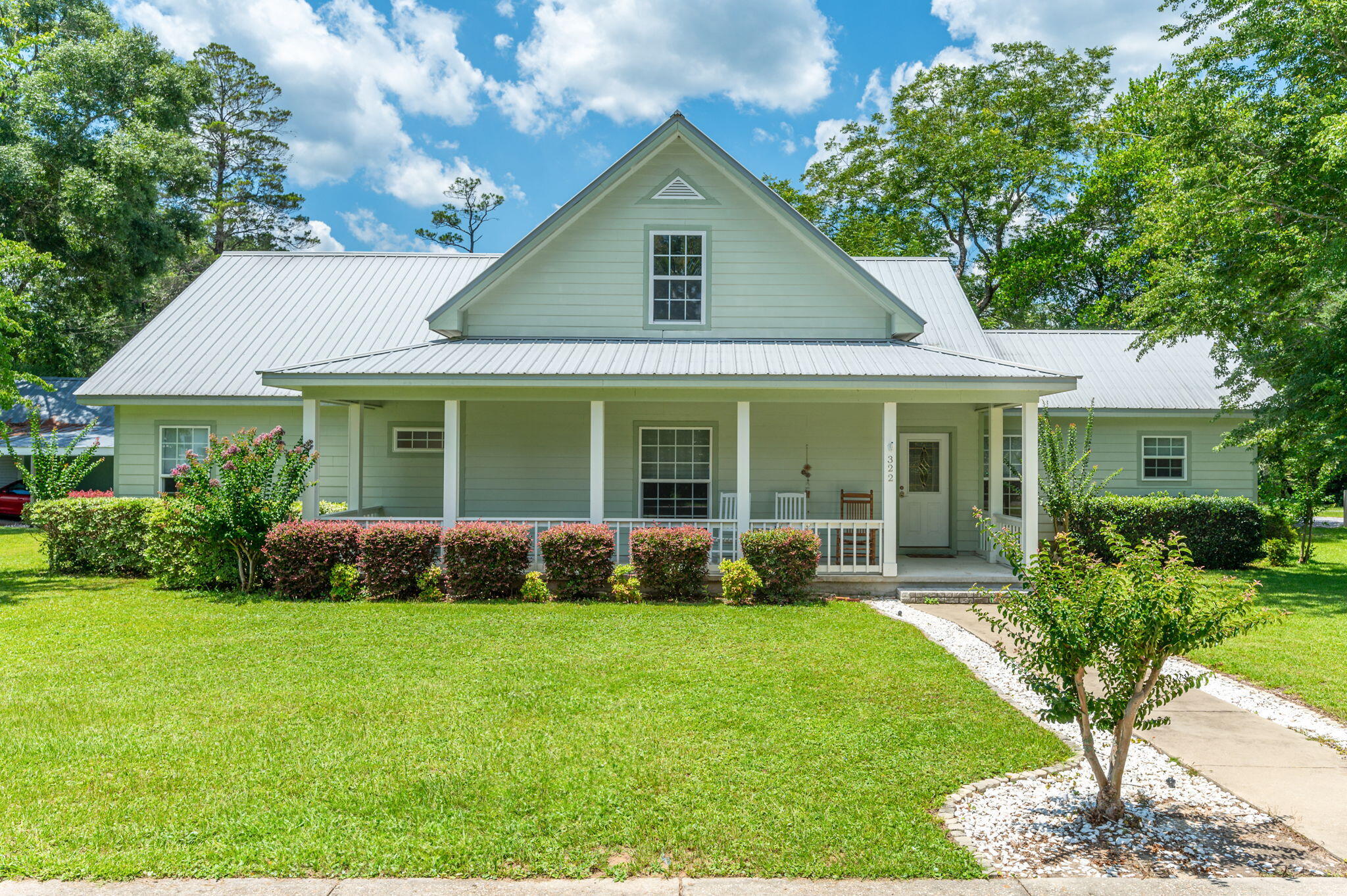 Explore this charming home nestled in the Historic District of DeFuniak Springs, just steps away from Lake DeFuniak Lakeyard. Meticulously designed, this residence boasts a spacious eat-in kitchen with oak cabinets, a walk-in pantry, and a convenient desk area. The living room features soaring 9 ft. ceilings throughout the downstairs.
The master bedroom offers a large walk-in closet and a master bath with a spacious shower and linen closet, while the second bedroom also includes a walk-in closet. Ample storage is available with three closets in the hallway, and the laundry room provides extra cabinets and counters. Upstairs, the home expands to over 2,300 square feet, offering flexibility for additional living space or storage. Moreover, the entire downstairs is ADA handicap accessible,