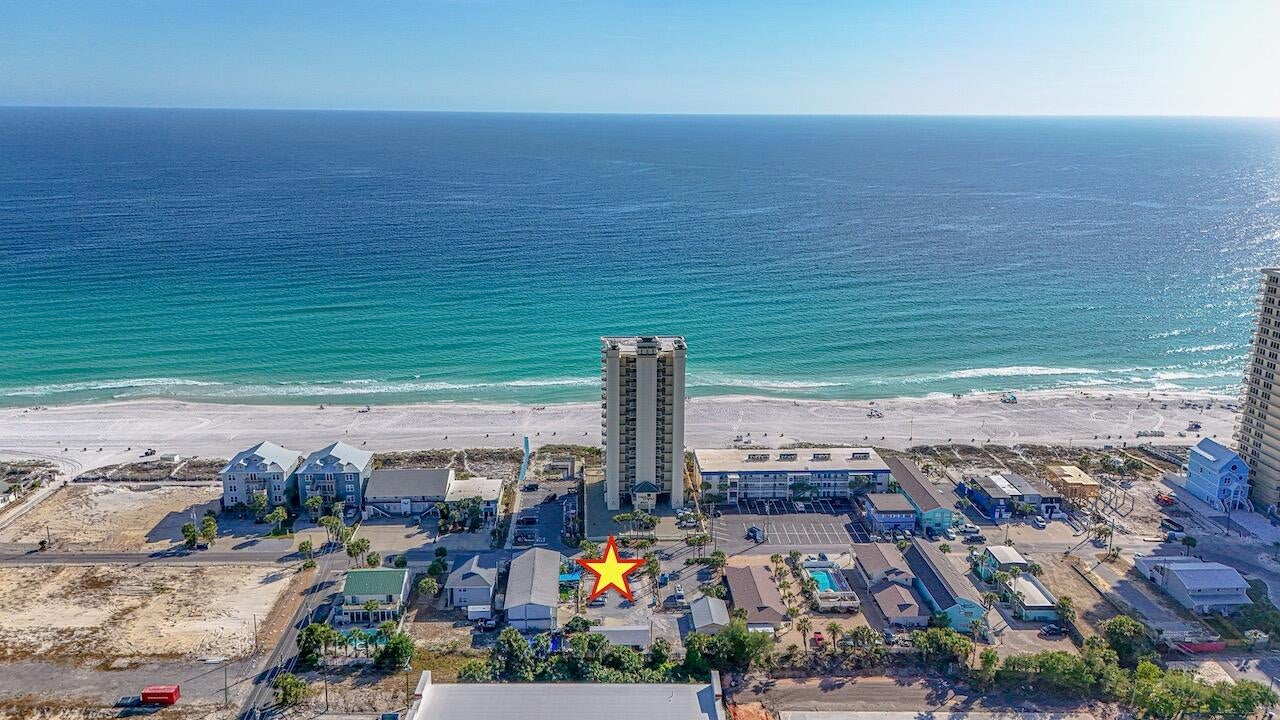 Exceptional Investment Opportunity in a Prime Beachfront Setting.  Notably, it boasts the only beach view from the north side of Surf Drive--an unmatched feature that sets it apart.  Embrace the charm of Old Florida with this rare 6-unit motel situated on over half an acre in one of the most desirable locations along Surf Drive. Rich in character and coastal appeal, this income-producing property offers a unique blend of nostalgia and modern potential.  Currently operating as a turnkey business, this thriving Bed and Breakfast is fully furnished and well maintained, providing immediate income with strong demand driven by Panama City Beach's thriving tourism market. Guests enjoy convenient beach access just steps away, along with walkable proximity to dining, entertainment, and local attractions.  The expansive lot and high-intensity zoning present exceptional redevelopment opportunities. Whether you envision expanding the existing footprint, creating a boutique lodging experience, or developing single-family or multi-family residences, the possibilities are wide open.  With its prime location, steady rental potential, and rare development flexibility, this property is an outstanding opportunity for investors seeking both current cash flow and long-term upside in a highly sought-after coastal market.