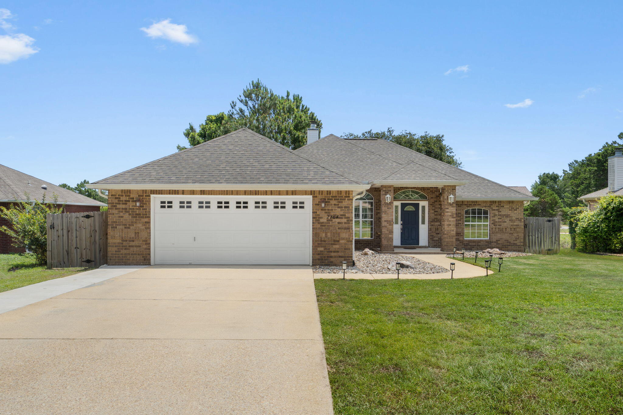 Enjoy peaceful water views from this beautifully maintained all-brick 3-bedroom, 2-bath home situated on a spacious lot along a quiet cul-de-sac in a desirable non-HOA subdivision near Hidden Creek Golf Course and just a short drive to the sugar-white sands and emerald waters of Navarre Beach. Have peace of mind knowing the major systems have already been updated, including a 2021 roof, 2019 HVAC system, and water heaters replaced in 2023 and 2025. Inside, you'll find an open-concept floor plan enhanced by custom touches such as arched doorways, bullnose corners, crown molding throughout the common areas, tray ceilings with additional crown molding details, ceiling fans, and a cozy fireplace in the living room. Luxury vinyl plank flooring flows through the living and formal dining rooms, while tile flooring is featured in the kitchen and bathrooms. The main living area also includes a built-in dry bar with a granite countertop and storage, perfect for entertaining. As an added bonus, the mounted flat-screen TV in the living room will remain with the home.

The spacious kitchen is designed for both everyday living and entertaining, featuring granite countertops, stainless steel appliances including a French door refrigerator, soft-close drawers, drop-down pendant lighting over the breakfast bar with seating, a separate eat-in dining area, and a formal dining room for larger gatherings. The oversized walk-in pantry measures nearly 5' x 8' and includes its own utility sink for added convenience. The private primary suite offers a true retreat with surround sound wiring and a spacious en-suite bath featuring 18-inch tile flooring, double vanities, a deep garden tub, private water closet, and a walk-in, step-down tiled shower complete with a window for natural light. An additional 50-gallon water heater serves the primary bath, providing extra comfort and convenience.

Two generously sized guest bedrooms offer ample closet space and comfortable accommodations for family and guests. A separate interior laundry room comes complete with a washer, dryer, and an additional utility sink. There is also brand new carpet (installed June 2026) in all 3 bedrooms that has never been lived on!

Just off the living room, sliding glass doors open to a bright Florida room that leads to the back patio, creating the perfect space to enjoy the surrounding views year-round. The covered patio overlooks the fishing pond and peaceful backyard setting. Beyond the privacy-fenced yard, the property extends to a tranquil fire pit area - ideal for relaxing evenings and gathering with friends while taking in the natural beauty of the landscape. Welcome home!
