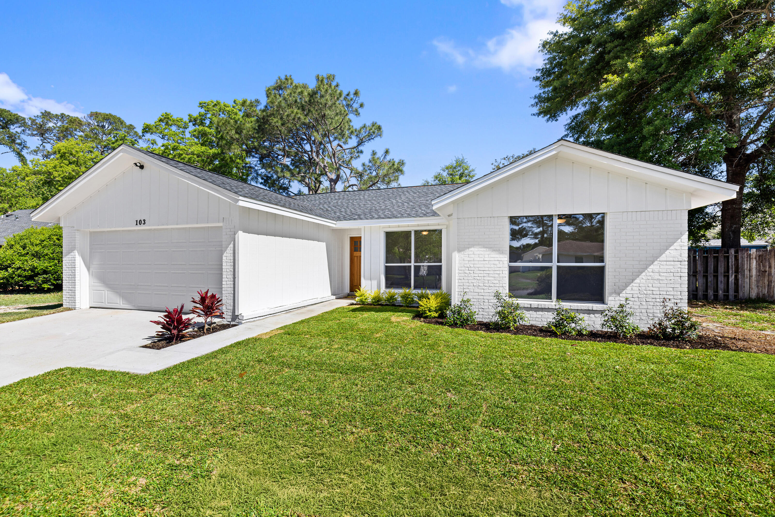 Consider stepping into this beautifully refreshed home just in time to party for the 4th of July holiday! This bright and revitalized home is centrally located in the Niceville neighborhood of Palm Estates and features a new dimensional roof with skylights for increased natural light. Split Bedroom floor plan and no popcorn ceilings, fresh interior and exterior paint, new waterproof and pet friendly LVP flooring throughout makes life easier. The updated kitchen shines with all new stainless steel appliances, new soft close cabinetry with hidden hinges, brushed brass hardware and quartz countertops. Both bathrooms have been completely renovated with new vanities, toilets, and stylish new finishes--plus a walk in shower in the primary suite.  Click Read More Additional upgrades include new ceiling fans and stylish light fixtures, all new interior and exterior doors, a new hot water heater, and a new overhead garage door with automatic opener. Exterior improvements feature a new 2 car driveway, front sidewalk, garage side-entry stoop, and a 12x20 poured patio perfect for outdoor living. Generous, newly privacy fenced backyard provides plenty of romping room for the young at heart, and a new patio to chill while watching the young'uns with a tall glass of peach flavored southern sweet iced tea. This move in ready home blends modern comfort with thoughtful design and low home maintenance. Unpack and head to the beach!