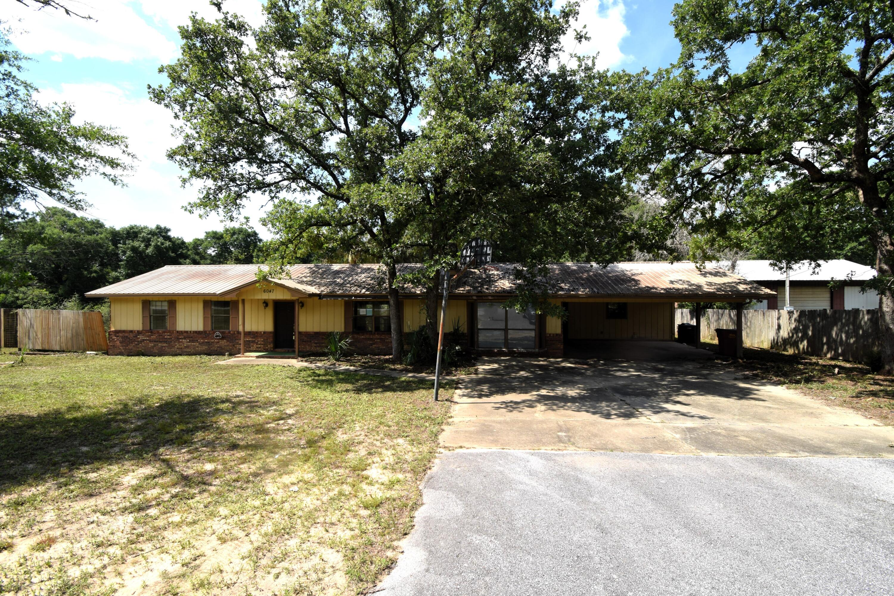 Real Estate Owned property located in growing North Crestview. This brick ranch style home offers 4 bedrooms and 3 full bathrooms and is situated on approximately 1/2 acre. The layout includes spacious living areas, a kitchen with ample cabinetry, and generously sized bedrooms. The primary bedroom features two oversized walk in closets and an additional secure interior space. Exterior features include an in ground pool and a fenced backyard with privacy fencing designed to allow airflow. Property offers country style living with no city taxes. Convenient location with easy access to shopping, schools, and major roadways. Call to take a look at 6047 Eden Square today.