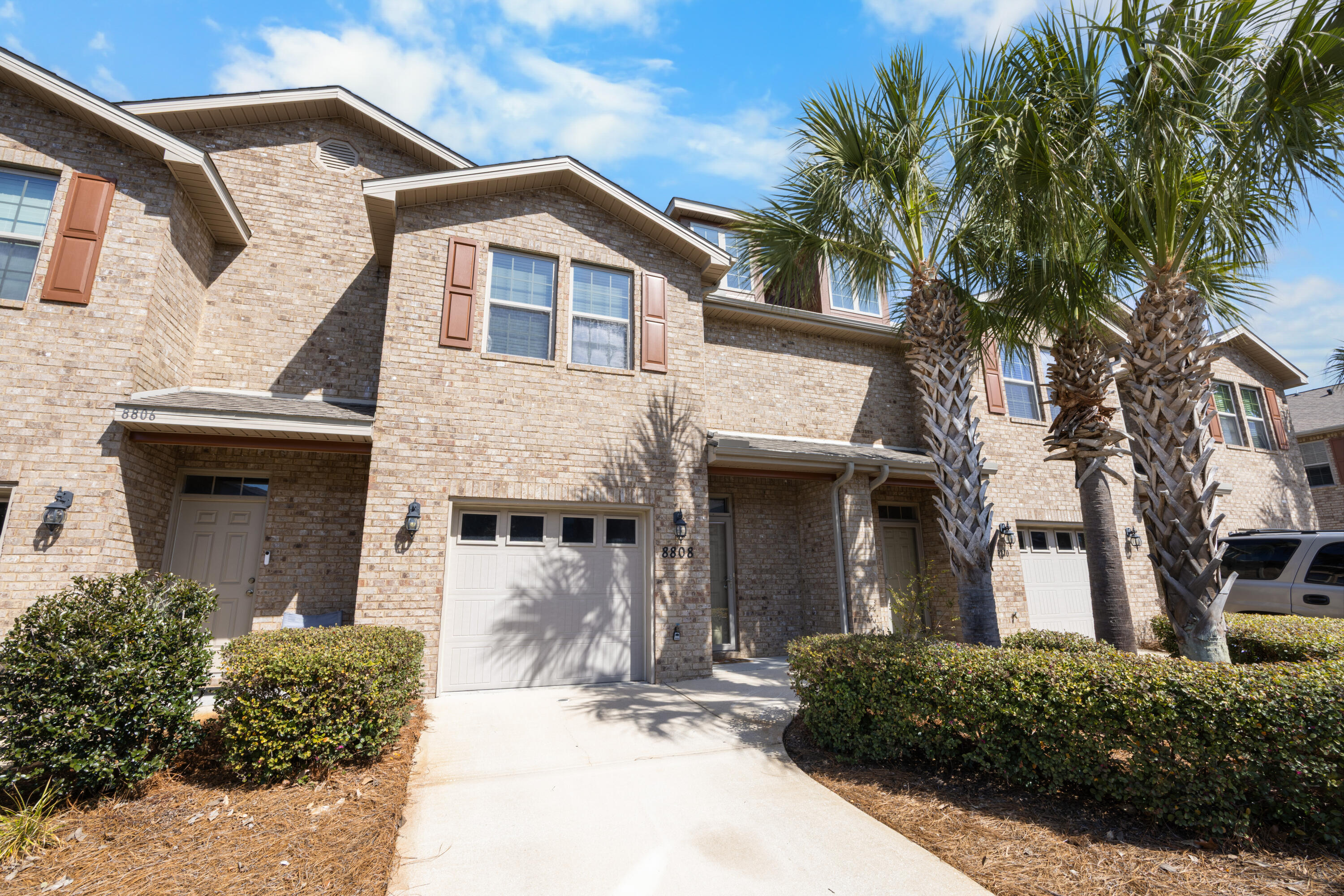 *Presented with staging furniture* Welcome to 8808 Brown Pelican Circle in Navarre, Florida, a beautifully maintained townhome located in the highly sought-after Reserve Pointe community. Perfectly positioned just 4 miles from the white sands of Navarre Beach, approximately 13 miles to Hurlburt Field, and about 36 miles to Pensacola Beach, this home offers the ideal blend of convenience and coastal living.
Reserve Pointe is known for its lifestyle-focused amenities, including a resort-style swimming pool, playground, and professionally maintained landscaping, creating a welcoming environment for residents and guests alike.

Inside, you'll find durable wood-look vinyl flooring throughout the main level, combining style and functionality. The kitchen is thoughtfully designed with stainless s teel appliances, granite countertops, a modern backsplash, and rich cabinetry, offering both elegance and everyday practicality. The open-concept layout provides a bright and inviting living and dining space, perfect for entertaining or relaxing at home. A convenient half bath is also located on the first floor.

Upstairs, the spacious primary suite serves as a private retreat, featuring an en-suite bathroom with double vanities, granite countertops, and a walk-in shower. Two additional bedrooms are serviced by a second full bathroom with a shower/tub combination, offering flexibility for guests, family, or a home office setup.

Step outside to enjoy a fully fenced backyard accented by a tropical palm tree, creating a private and relaxing outdoor space.