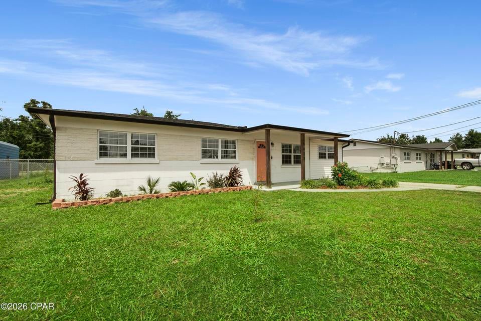 Welcome home! This beautifully maintained 4-bedroom, 2-bathroom home offers the perfect combination of comfort, functionality, and convenience. Situated on a large lot along a quiet dead-end street, this property immediately stands out with its beautiful landscaping and inviting curb appeal. Inside, you'll find an open-concept layout with LVP flooring throughout. The split-bedroom floor plan is ideal for added privacy. The kitchen has been updated and features stainless steel appliances, butcher block countertops, and a dedicated coffee bar, making it a perfect spot to start your morning! The home also offers a sunroom, separate laundry room, and plenty of functional living space. Step outside to enjoy the fully fenced backyard, providing room to relax, entertain, garden, or let the kids and pets play. The detached garage adds even more versatility and is ideal for a workshop, lawn equipment, golf cart, storage, or hobby space. Incredible home on an incredible lot that sits between two streets, Lois and Katherine. Location is another major plus! You're conveniently located near Tyndall Air Force Base, restaurants, coffee shops, and multiple grocery options, with Winn-Dixie, Walmart, and Aldi all within approximately a mile. Enjoy easy access to both Mexico Beach and Panama City Beach, while the bay is less than 5 miles away. Nearby boat ramps and a marina are just minutes away, providing convenient access to St. Andrews Bay from East Bay. If you've been looking for a home with space, a fenced backyard, and an unbeatable location, this one deserves a closer look!