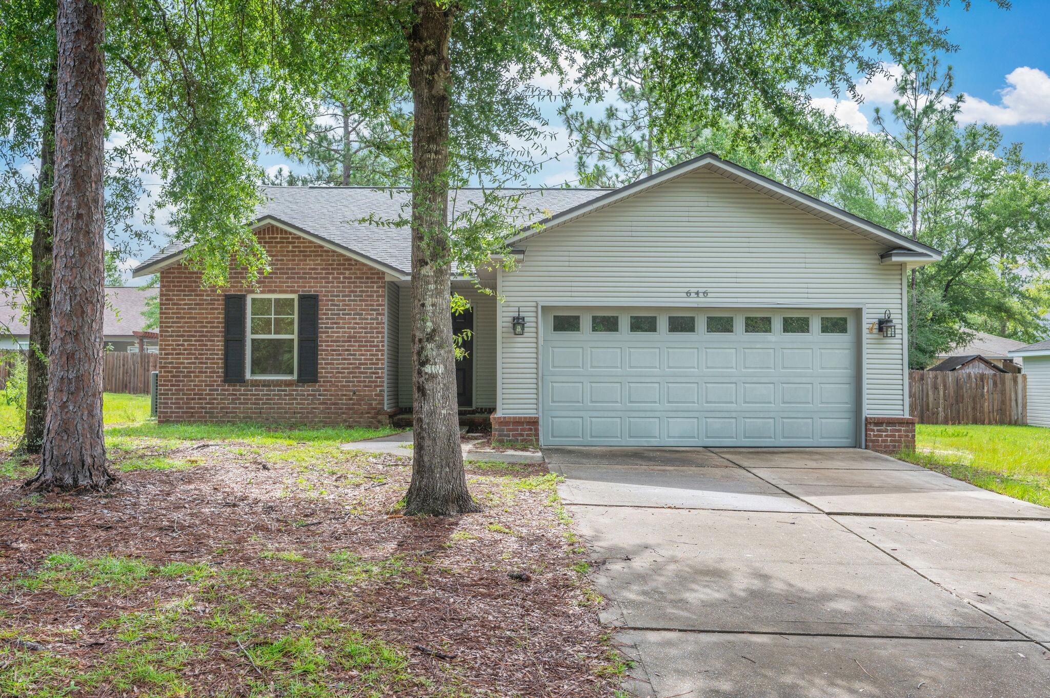 This beautifully maintained 3-bedroom, 2-bath home in the private and peaceful Hunter's Ridge neighborhood offers comfort, space, and convenience all in one. Featuring 1,466 square feet, the home boasts a split floor plan, vaulted ceilings, and brand-new waterproof LVP flooring throughout. The open living, dining, and kitchen area includes a center island, pantry, and plenty of counter space--perfect for everyday living and entertaining. Enjoy a spacious covered back porch overlooking the backyard, ideal for relaxing or outdoor meals. The primary suite includes a walk-in closet and double vanity, and there's a large two-car garage and separate utility room for added convenience. Located just minutes from schools, shopping, and downtown DeFuniak Springs.