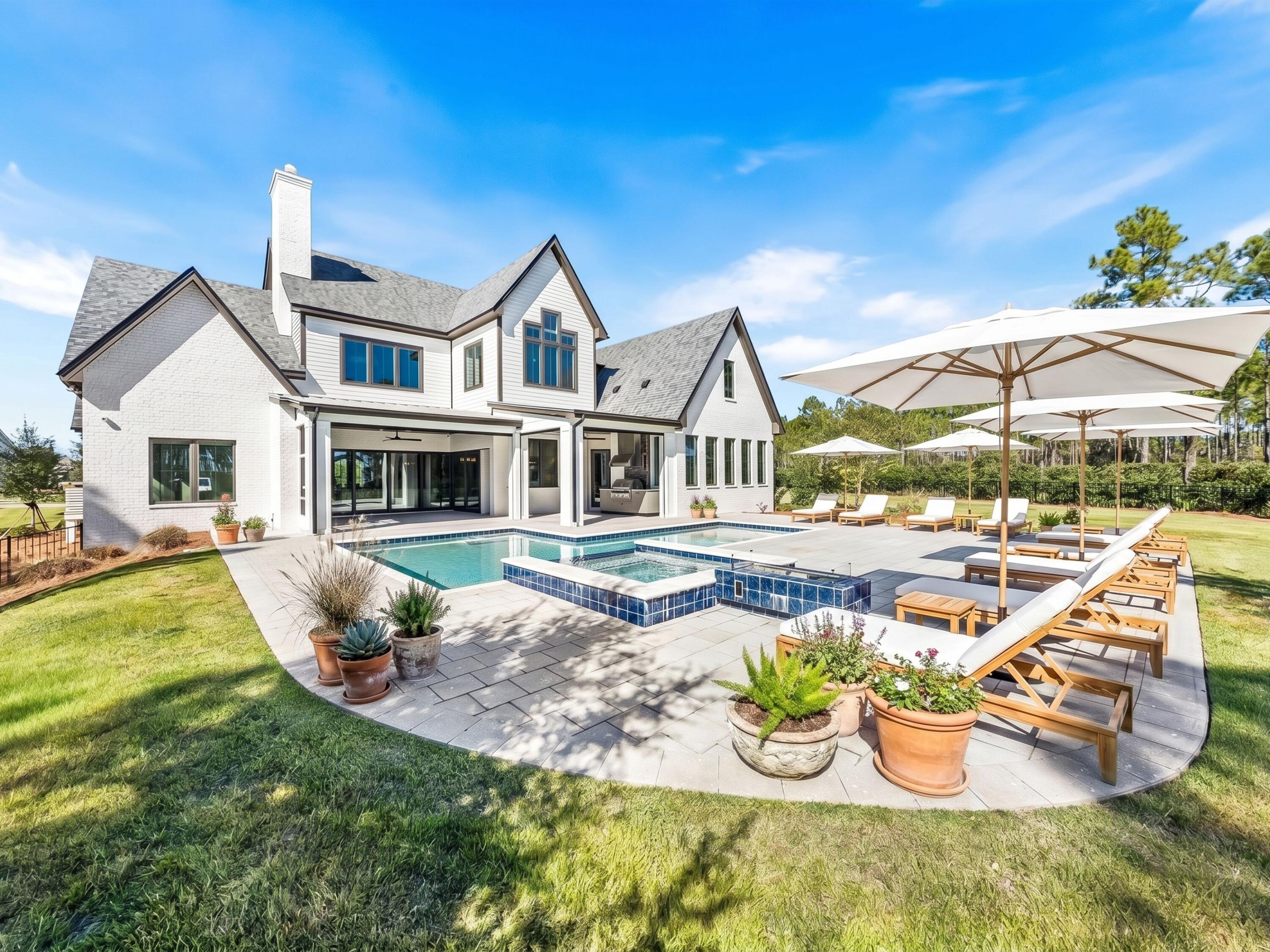 This magnificent residence is situated on .43 acres in the coveted community of Watersound Camp Creek which is a much larger homesite than most of the neighborhood. 172 Norman Court pairs 5,501 square feet of thoughtfully designed living space with finishes and features that are difficult to match for under $5 million. To help visualize furniture placement many of the photos have been digitally staged. The main level is built around a central open-concept living area with hardwood floors, custom built-ins, and a linear gas fireplace. NanaWall sliding doors erase the boundary between the indoor living space and the outdoor kitchen and porches, creating a single entertaining footprint that flows from the kitchen island to the pool terrace without interruption. The kitchen features commercial-grade stainless appliances with a six-burner range and skillet, custom cabinetry,

and a large center island. A hidden scullery includes an additional refrigerator, dishwasher, sink, and deep pantry storage which keeps the main kitchen in pristine condition while entertaining. A 200-plus bottle climate-controlled wine room and a dedicated wine cooler in the dining area are included.
The primary suite is on the main level. It features a tray ceiling, a generously scaled ensuite with raised ceilings, designer tile, soaking tub, oversized shower, an expansive walk-in closet, and a dedicated safe room. A first-floor guest bedroom with ensuite bath, full laundry room, and a sand room with built-in storage complete the ground level. An integrated Sonos sound system runs throughout the home.
The outdoor living area is designed for year-round use. Retractable motorized screens enclose a covered space with summer kitchen, gas fireplace, and seating for large groups. The spacious backyard opens up to the heated pool and spa enclosed by a permanent wooded buffer so no future construction or neighbors.

The second floor offers an expansive secondary living area with wet bar that is large enough to function as a game room, home theater, or golf simulator space. Three additional bedrooms, each with its own full ensuite bath, complete the upper level. Every bedroom in this home has its own ensuite bath. Other notable features of this all brick residence include the attached 3-car garage and dedicated office.
Ownership conveys exclusive Watersound Club membership -- three golf courses including the Tom Fazio-designed Camp Creek course and the new Davis Love III-designed The Third course, gulf-front Beach Club with complimentary chair and umbrella service, 11,000-square-foot wellness center, resort pools, tennis and pickleball courts, and multiple private dining venues. Fewer than 15 developer homesites remain in the community.