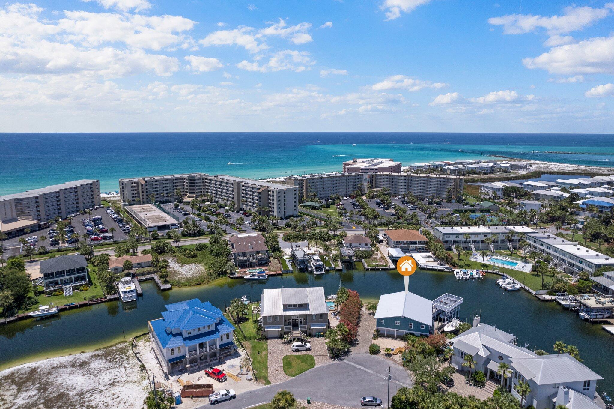 Amazing opportunity to own one of the largest lots on sought after Holiday Isle in Destin. This exceptional property boasts over 170 ft of canal frontage, nearly double most lots on The Isle. With 2 true deep water boat slips, one lift, a jet ski slip, plus additional day boat docking area, and still room to add a pool (permitting required). The sizable lot offers a rare canvas in one of Destin's most coveted waterfront neighborhoods, where lots of this scale and frontage almost never come to market. The existing 3-bedroom home with 2 bonus rooms and over 2,700 sq ft of decking overlooking the canal is a classic coastal cottage ready for your vision. Update it, reimagine it, or start from scratch. The bones are here but the real value is the land, the water, and the location.