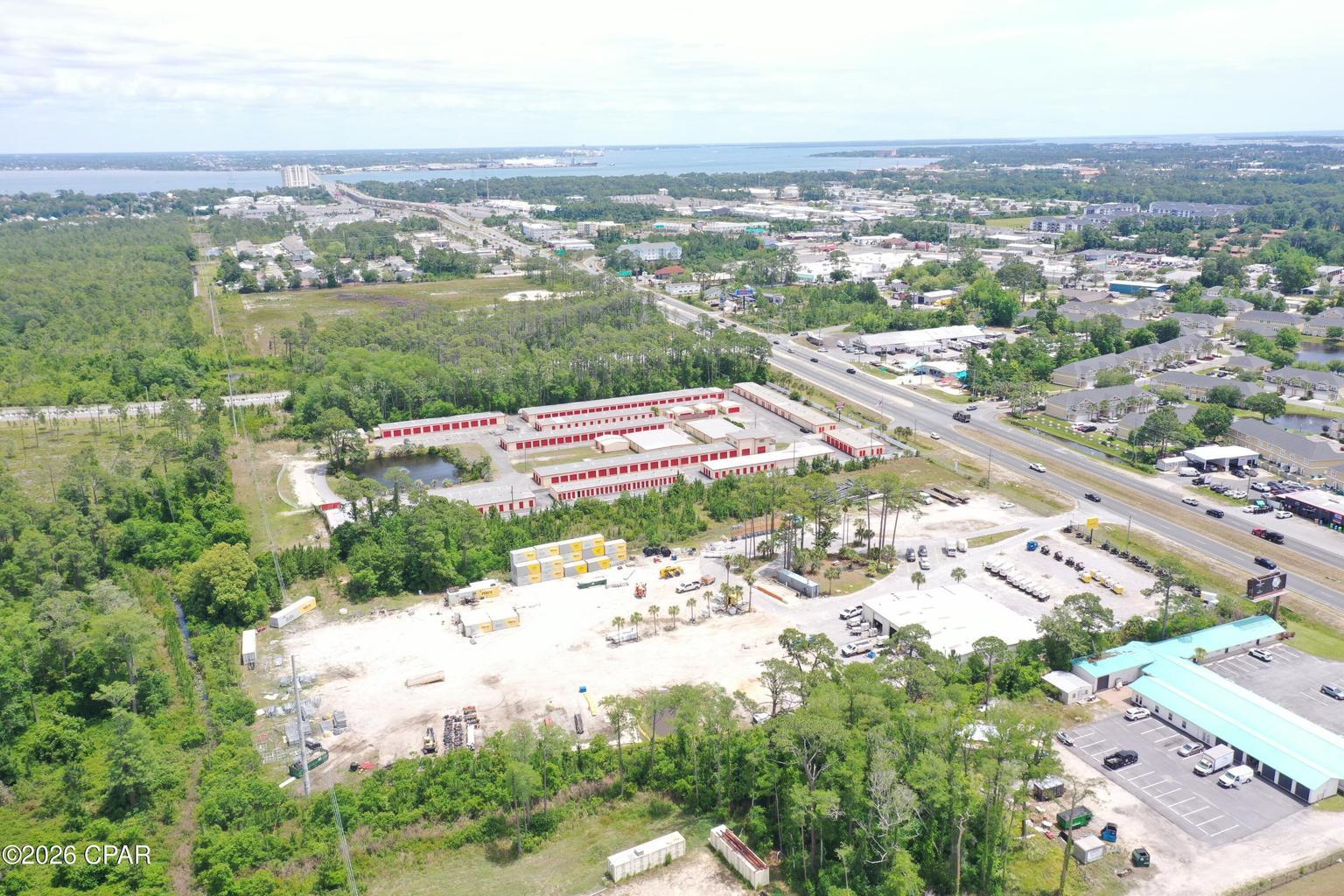 Exceptional commercial development site located on highly traveled Panama City Beach Parkway in the center of the fastest-growing corridors in Panama City Beach. This high-visibility parcel is zoned GC-3 General Commercial within unincorporated Bay County. The property includes approximately 345 feet of frontage on Panama City Beach Parkway with 700 feet of depth. The annual average daily traffic count is estimated at an impressive 44,500 vehicles. The property provides outstanding flexibility for retail, mixed-use, hospitality/hotel, multi-family, medical, automotive, restaurant, self-storage, office, or large-scale commercial development opportunities. Strategically positioned near the rapidly expanding Publix Sports Park corridor on Chip Seal Parkway, the property benefits from substantial ongoing residential, recreational, and infrastructure growth throughout the surrounding area. The sports complex features championship-caliber soccer and multi-purpose athletic fields that attract year-round regional and national tournaments, generating significant visitor traffic and economic impact for the area. The site is also located near the new A. Gary Walsingham Academy Elementary School and continuing residential expansion surrounding the Breakfast Point and Chip Seal Parkway developments, creating strong long-term demand drivers for commercial services, retail, restaurants, medical users, and neighborhood-oriented businesses. Additional area growth is being fueled by ongoing roadway and infrastructure improvements, including the expansion and connectivity plans surrounding Philip Griffitts Parkway and Chip Seal Parkway, designed to improve traffic flow and accessibility throughout Panama City Beach. The property also includes a large building with 9,180 square feet of space. The building includes approximately 5,000 square feet of warehouse, four--12' x 14' roll up doors, 14' clear ceiling height, and 4,000 square feet of office-showroom. The property is currently leased by HERC Rental with the lease expiring on May 31, 2027. Property Highlights " Approximately 345' of Panama City Beach Parkway frontage " Excellent visibility and accessibility " AADT 44,500 " Minutes from beaches, schools, sports facilities, and major residential growth " Located within a rapidly expanding commercial corridor " Ideal for hospitality, mixed-use, medical, automotive sales, or investment development With continued explosive growth throughout the east end of Panama City Beach and limited remaining commercial frontage opportunities along this corridor, this property represents a premier long-term investment and development opportunity.