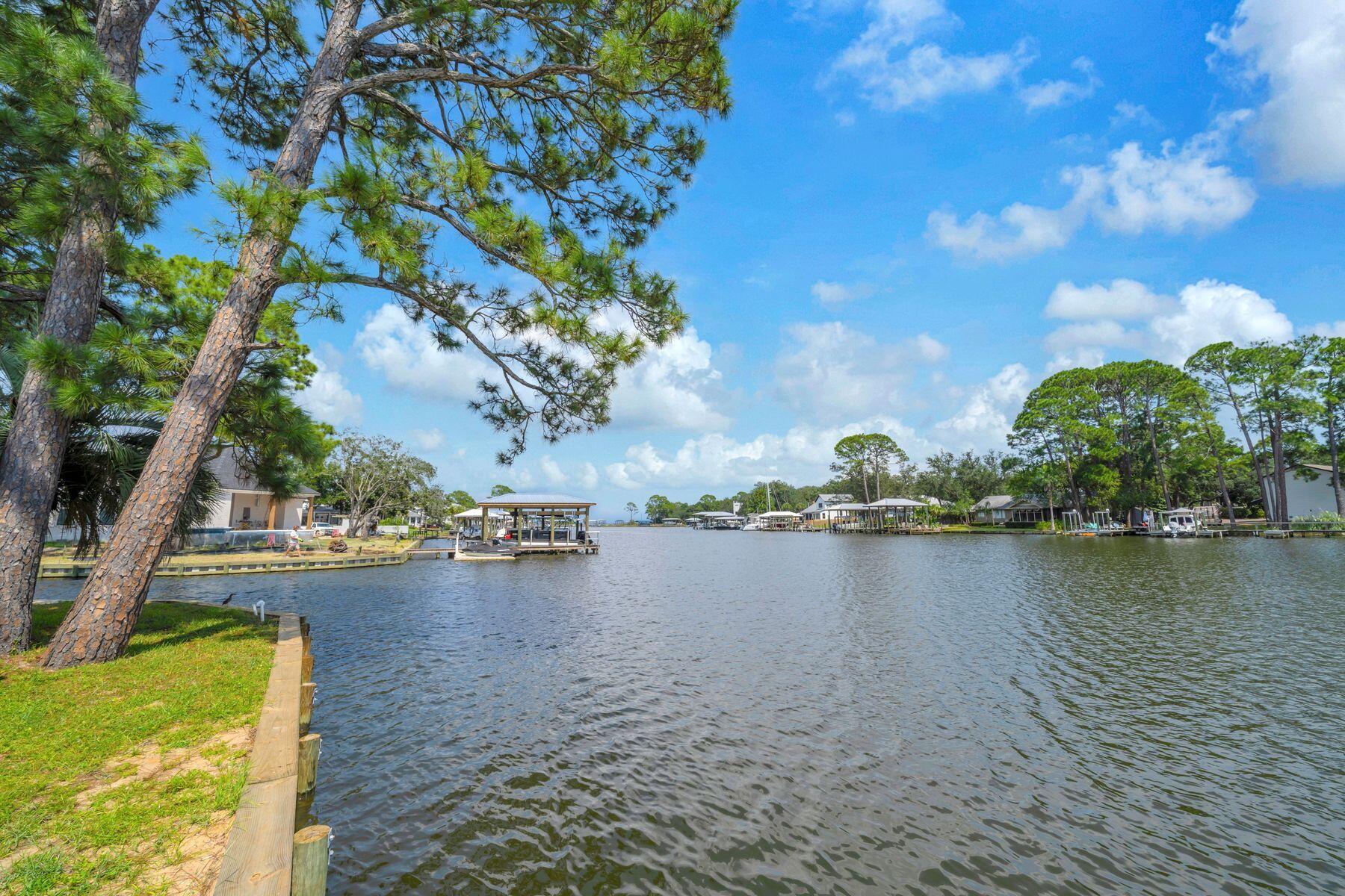 Majestically gated and surrounded by estate homes, this premiere deep water homesite in Hidden Harbor offers 153 feet of waterfront on Buck Bayou. This serene and private setting is located just 300 yards from Choctawhatchee Bay, providing an ideal canvas for construction on a site that is already cut, cleared, and ready for development. The property is fully equipped with a new bulkhead, a dock, and a boathouse featuring a boat lift. Additional on-site amenities include two storage buildings, one of which is conveniently plumbed for a bathroom. It is situated just minutes from the crystal blue gulf waters of the 30-A beaches.  Premier dining, medical facilities, and the Shops of Grand Boulevard are located just down the street. This site offers a rare opportunity to custom build your home and live the dream lifestyle on Florida's Emerald Coast.
