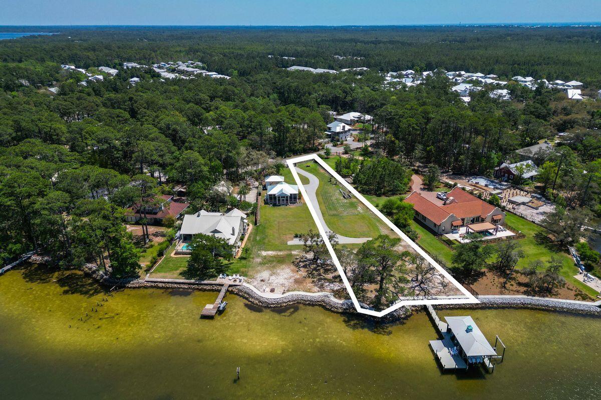Set behind a private gated entry, this exceptional 0.74-acre homesite on Hewett Bayou offers more than 100 feet of pristine bay frontage, direct deep-water access, and an unrivaled waterfront lifestyle. With no HOA restrictions, the property is ideal for boaters, nature lovers, and those seeking privacy, space, and serenity along the coast.

One of the last west-facing, deep-water opportunities available on Choctawhatchee Bay, this premier homesite captures breathtaking sunset views across the open water. Its navigable depth, expansive frontage, and private setting create an increasingly rare opportunity to design and build a distinctive waterfront estate.

The property is thoughtfully improved with exceptional marine infrastructure designed for performance and longevity. The expansive dock features composite decking, a lower flow-through platform, two boat lifts, and a covered boathouse capable of accommodating vessels over 30 feet. A durable vinyl sheet seawall, reinforced with substantial riprap, provides long-term shoreline stability and protection.

For those seeking even greater possibilities, the adjoining property to the north is also available for purchase (MLS 1009266), creating the rare opportunity to own a true double-lot waterfront compound. Together, the two parcels offer exceptional flexibility for a private family estate, guest accommodations, expanded outdoor living, or a multigenerational retreat. The neighboring property includes a charming two-bedroom, two-bath cottage with an expansive screened outdoor living area, providing immediate enjoyment while you envision and build your dream waterfront residence.

This is a truly exceptional opportunity to secure one of Choctawhatchee Bay's most desirable west-facing, deep-water homesites--with the rare option to expand into an extraordinary legacy waterfront estate.