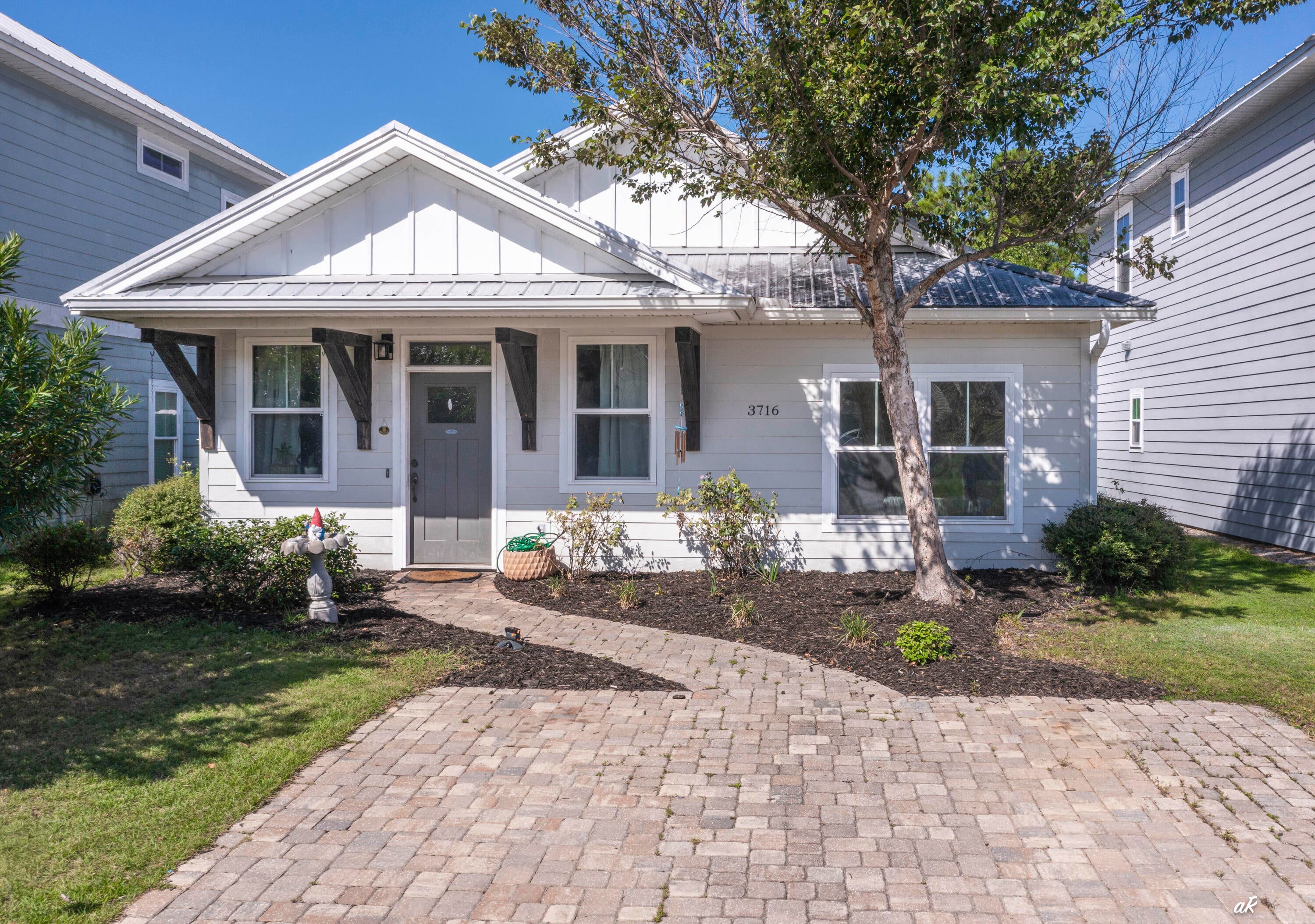 YOUR SLICE OF PARADISE AWAITS! Welcome to 3716 Tiki Drive, a beautifully upgraded Florida cottage with Rosemary Beach-inspired charm, modern finishes, and an unbeatable Panama City Beach location. Just minutes from the beach, local restaurants, and popular destinations like Captain Anderson's, Schooners, and The Grand Marlin. Step inside to a bright and inviting open floor plan featuring 9-foot ceilings, wood-look tile, and a stunning kitchen with white cabinetry, granite countertops, and stainless-steel appliances. The split-bedroom layout offers privacy, while the spacious primary suite features an upgraded tray ceiling and beautiful natural light. Outside, enjoy room for entertaining, relaxing, or letting the pets play, along with access to the community pool, perfect for cooling off and enjoying the Florida sunshine. Whether you're searching for a full-time home, beach getaway, second home, or investment property, this home checks the boxes. Coastal style. Prime location. Community pool. Move-in ready. Come see why 3716 Tiki Drive deserves a spot at the top of your list!