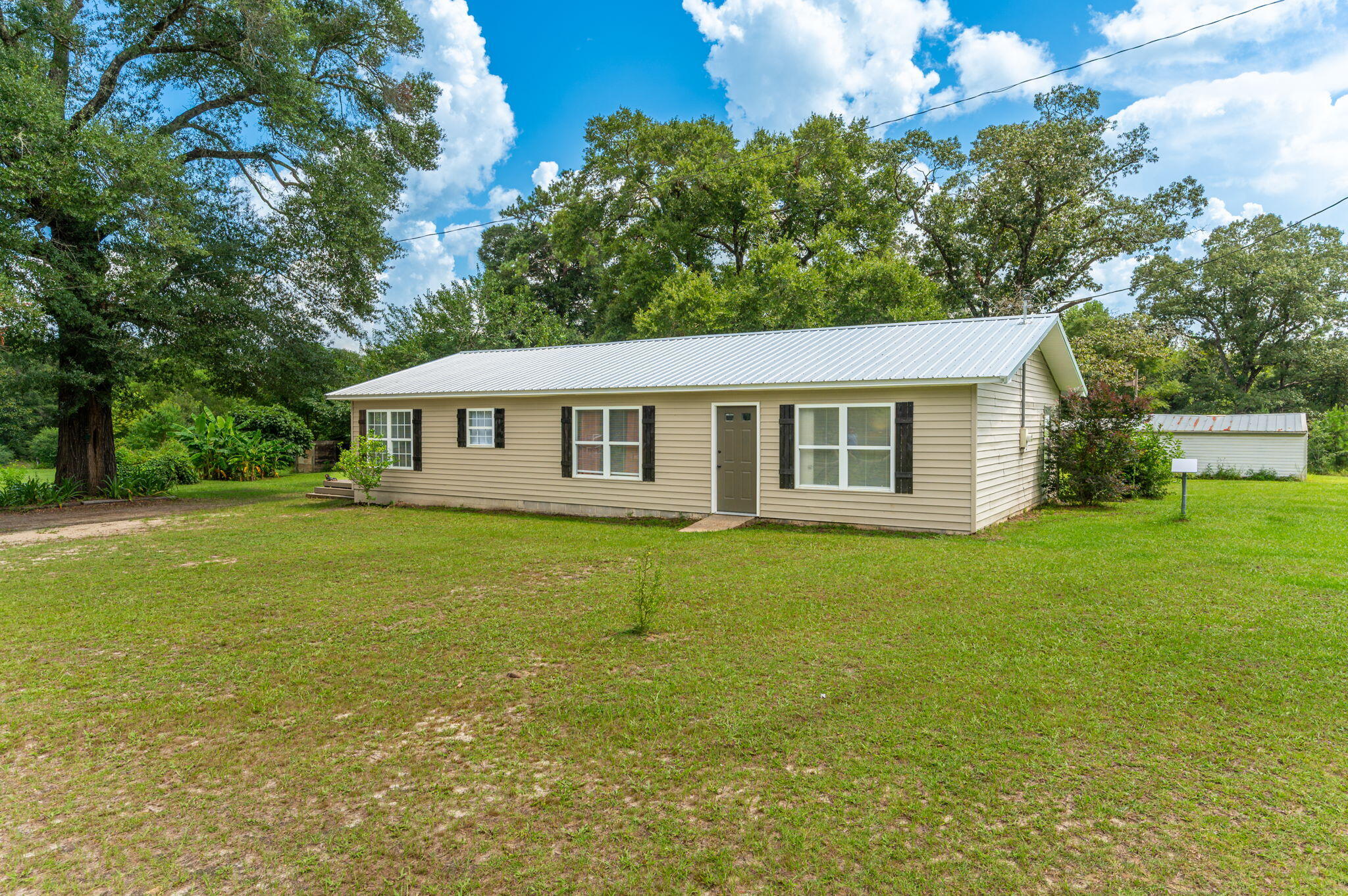 $10,000 closing cost credit with acceptable offer!!!

Country Living with Room to Grow! This 3BR/2BA ranch-style home offers the perfect opportunity to enjoy a little space and start your own mini-farm on 4.66+/- acres. The spacious kitchen and dining area provide plenty of room for the entire family to gather, while the large new walk-in pantry and oversized laundry room offer the storage and functionality that make country and farm life a little easier. Recent improvements include fresh interior paint, new LVP flooring throughout, remodeled second bathroom, 2025 roof, 2025 water heater, and 2022 HVAC. Outside, you'll find two electrical meters, an RV hookup, functional workshop, and pole barn providing plenty of room for equipment, tools, storage, or hobbies. To top things off your property is mostly fenced in and features a new covered back porch and an awesome open deck  that is perfect for entertaining or relaxing while you sit back and enjoy the country views looking out over your own paradise. Your new home is located less than 10 minutes to Florala/Lake Jackson, approximately 25 minutes to Crestview, and about an hour to Destin and the Emerald Coast beaches. Bring your vision and make this country property your own!